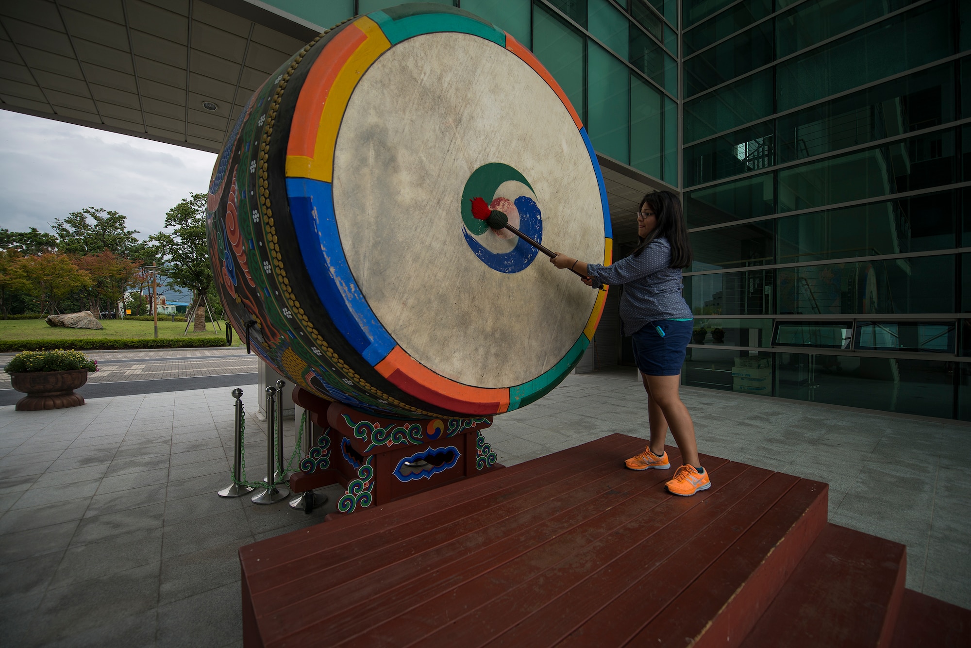 Cecelia Guadalupe Ortiz-Barreiro bangs a Korean buk July 26, 2014, in Chungju, Republic of Korea. Buks are used in traditional Korean folk music. The one pictured is one of the largest in the world. (U.S. Air Force photo by Staff Sgt. Jake Barreiro)