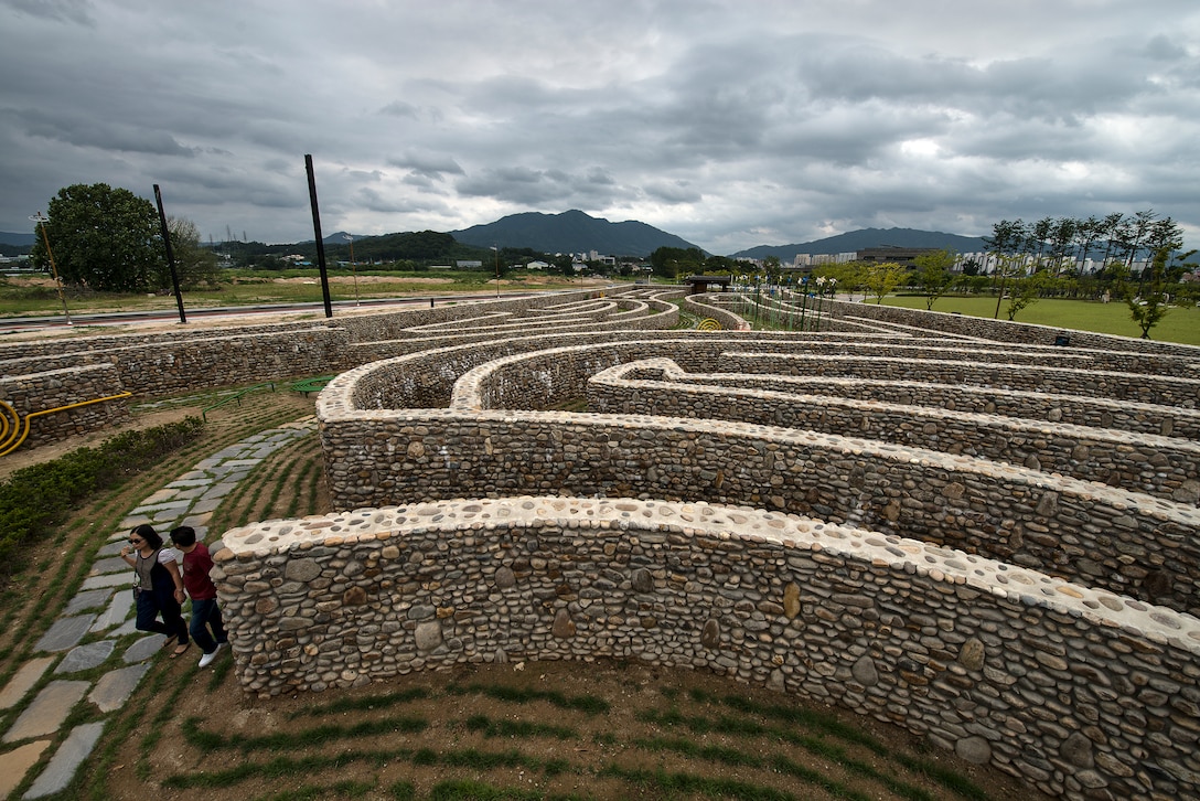 A couple walks through a stone-maze park July 26, 2014, in Chungju, Republic of Korea. Chungju is located in the geographical center of the peninsula of Korea, which made it a vaunted territory in ancient times. (U.S. Air Force photo by Staff Sgt. Jake Barreiro)