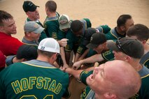 The 8th Maintenance Squadron Dragons celebrate after winning the squadron championship softball game at Kunsan Air Base, Republic of Korea, July 30, 2014. The game’s final score ended with the Dragons taking the win, 14 to 9. (U.S. Air Force photo by Staff Sgt. Jose Rodriguez/Released)