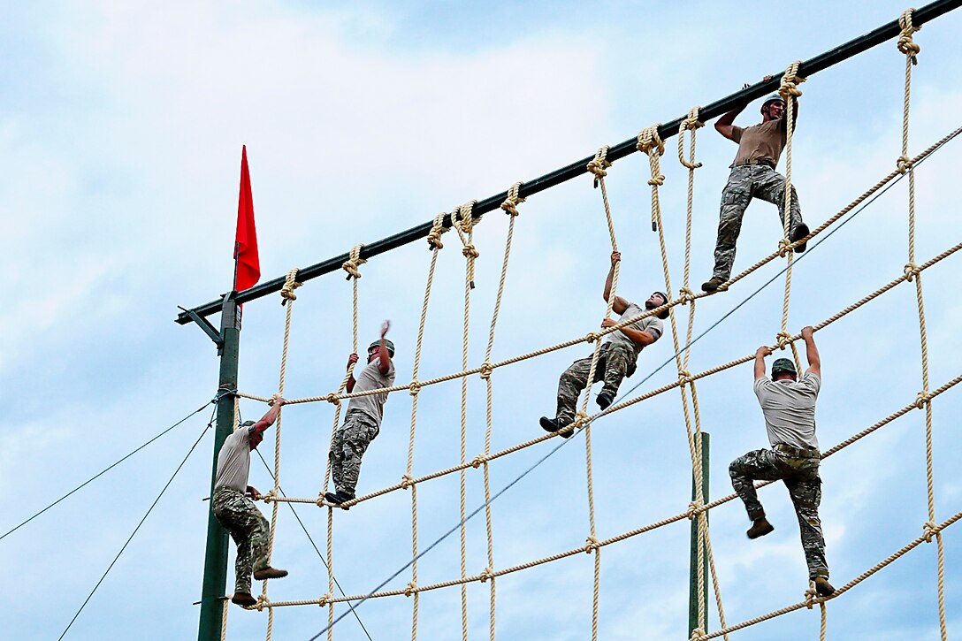 U.S. soldiers climb a rope wall obstacle course during Fuerzas Comando 2014 on Fort Tolemaida, Colombia, July 29, 2014. The soldiers are assigned to the 7th Special Forces Group. Fuerzas Comando 2014 is a U.S. Southern Command-sponsored special operations skills competition and fellowship program. 