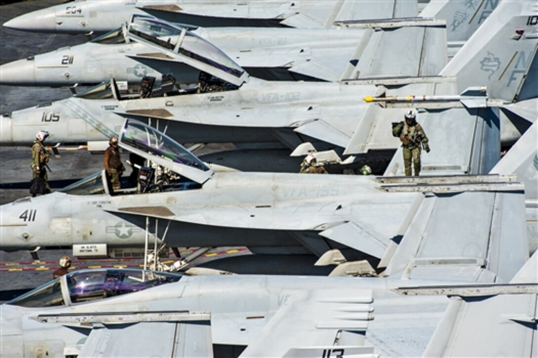 U.S. sailors prepare for flight operations on the aircraft carrier USS George Washington in the East China Sea, July 28, 2014. 