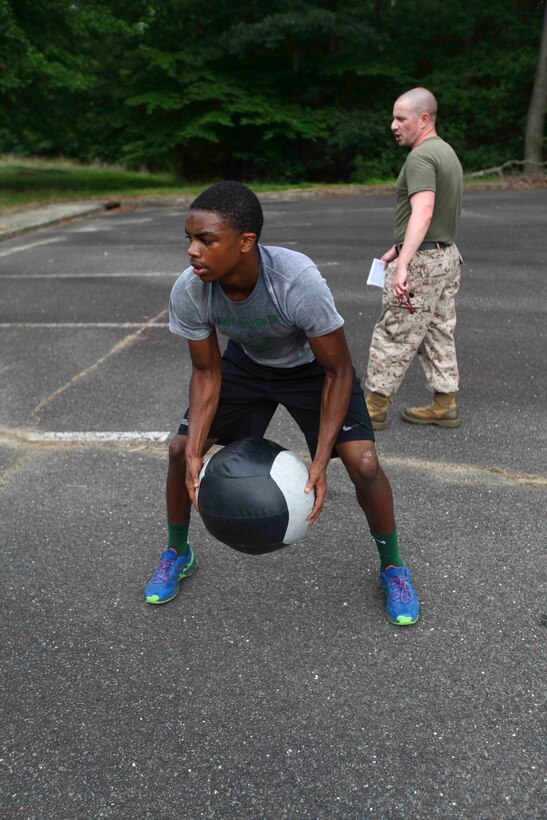 Bo Melton, a member of the Cedar Creek football team and a team leader, demonstrates modified burpies during the team competition at Naval Weapons Station Earle, Aug. 1. Recruiting Station New Jersey hosted a Leadership Seminar meant to impart Marine Corps leadership principles, discipline and camaraderie to members of the Cedar Creek. (United States Marine Corps photo by Lance Cpl. Brandon Thomas)