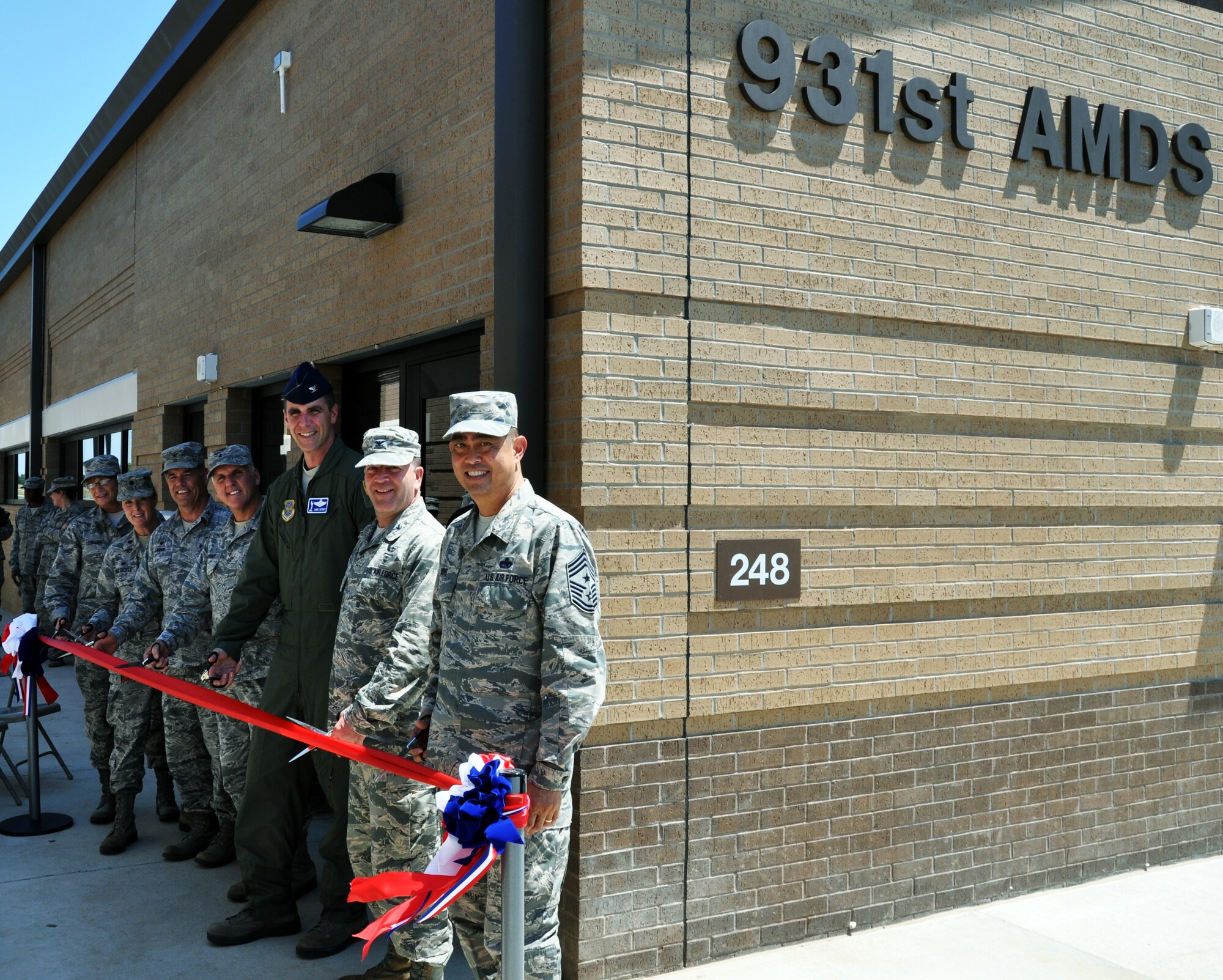 Chief Master Sgt. Kathleen Lowman, 931 ARG Superintendent, Lt. Col. Michelle Van Sickle, 931 AMDS Commander, Col. Mark Larson, 931 ARG Commander, Brig. Gen. John Flournoy, 4th Air Force Commander, Col. James Dermer, 22 ARW Vice-Commander, Col. Jeffery Alder, 22 MG Commander, and Chief Master Sgt. Brian Wong, 4th Air Force Command Chief Master Sergeant, cut the ribbon during the ribbon cutting ceremony for the new 931 AMDS facility at McConnell Air Force, Kan., Aug. 1, 2014. The new facility triples the number of work stations available for the 931 AMDS. (U.S. Air Force photo by Capt. Zach Anderson) 