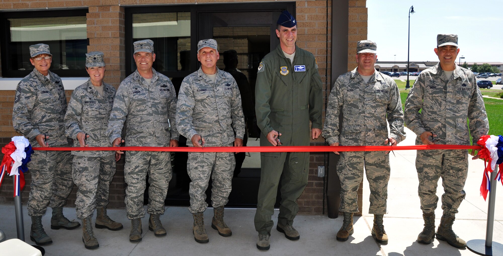 Chief Master Sgt. Kathleen Lowman, 931 ARG Superintendent, Lt. Col. Michelle Van Sickle, 931 AMDS Commander, Col. Mark Larson, 931 ARG Commander, Brig. Gen. John Flournoy, 4th Air Force Commander, Col. James Dermer, 22 ARW Vice-Commander, Col. Jeffery Alder, 22 MG Commander, and Chief Master Sgt. Brian Wong, 4th Air Force Command Chief Master Sergeant, cut the ribbon during the ribbon cutting ceremony for the new 931 AMDS facility at McConnell Air Force, Kan., Aug. 1, 2014.  The new facility triples the number of work stations available for the 931 AMDS.  (U.S. Air Force photo by Capt. Zach Anderson)