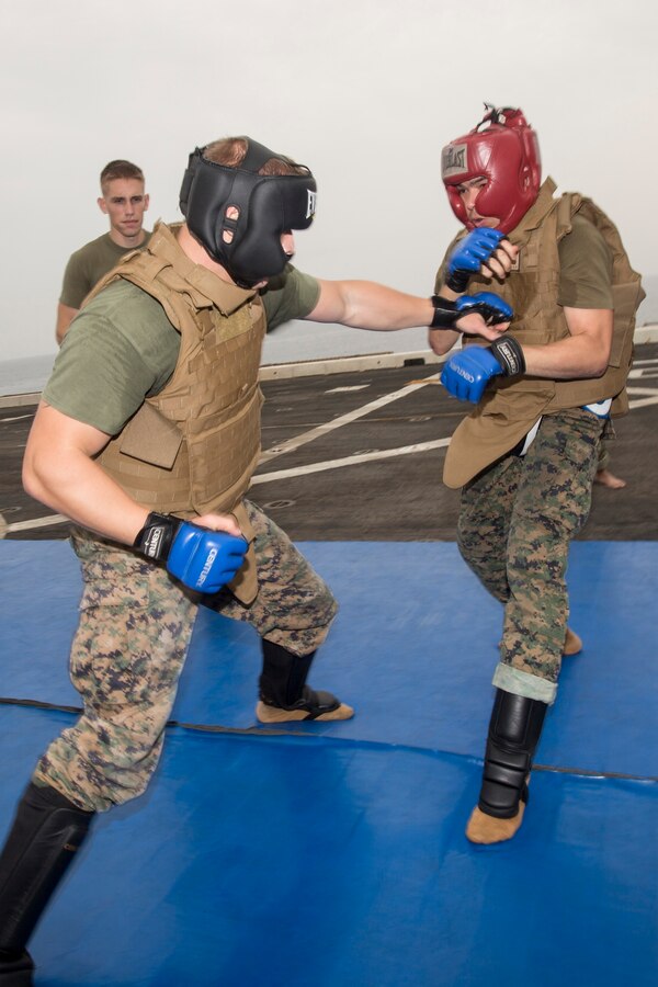 U.S. 5TH FLEET AREA OF RESPONSIBILITY (July 29, 2014) U.S. Marine Corps Sgt. Volodymyr Tumashev, left, Combat Logistics Battalion 22, 22nd Marine Expeditionary Unit (MEU), Marine Corps Martial Arts Program (MCMAP) instructor and native of New York, and Sgt. Daniel Rivera, amphibious transport dock ship USS Mesa Verde (LPD 19) Combat Cargo platoon sergeant and native of Okeechobee, Fla., spar as part of a MCMAP course aboard the Mesa Verde. The 22nd MEU is deployed with the Bataan Amphibious Ready Group as a theater reserve and crisis response force throughout U.S. Central Command and the U.S. 5th Fleet area of responsibility. (U.S. Marine Corps photo by Cpl. Manuel A. Estrada/Released)
