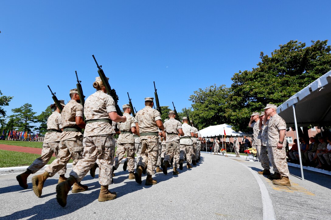 Commandant of the U.S. Marine Corps, Gen. James F. Amos, right, Maj. Gen. Raymond C. Fox, center, and Maj. Gen. William D. Beydler salute the passing of the colors during the II Marine Expeditionary Force (MEF) change of command ceremony at Camp Lejeune, N.C., July 17, 2014. Fox relinquished command as the commanding general of II MEF to Beydler. (U.S. Marine Corps photo by Sgt. Gabriela Garcia/Released)