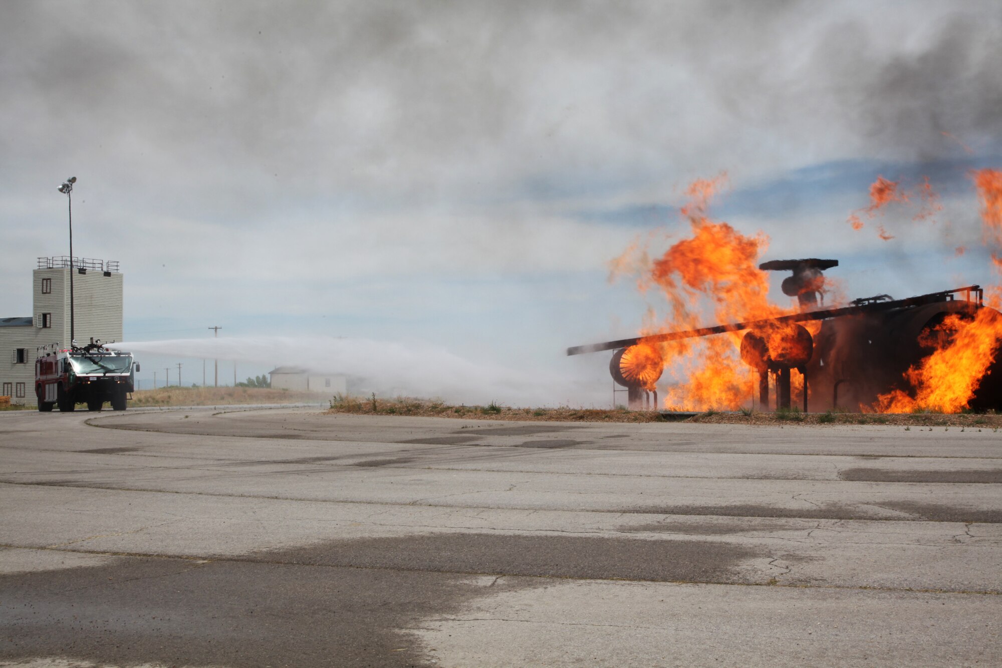 940th Fire Emergency Services Flight reservists use a Striker Vehicle to spray water during a live fire training exercise. The exercise prepares firefighters to fight aircraft fires. The 940th FESF trained at Hill Air Force Base, Utah to prepare for future stateside or overseas emergencies. (U.S. Air Force photo by Tech Sgt. Kenneth McCann/Released) 
