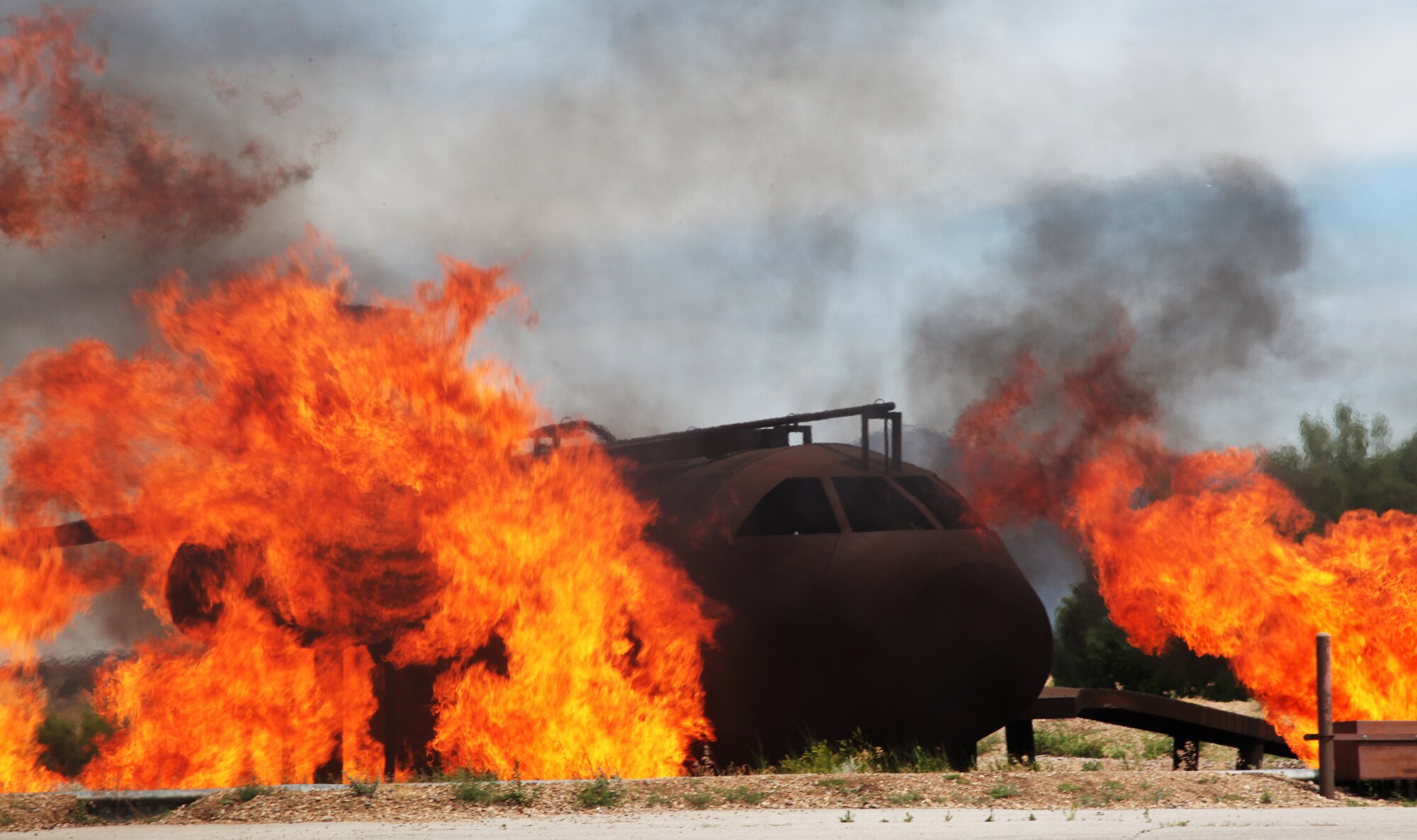 Flames engulf a KC-10 Extender mockup during a live fire exercise, Hill
Air Force Base, Utah. The aircraft training structure is equipped with propane gas tanks that produce flames to simulate a real world incident. 940th Fire Emergency Services Flight reservists from Beale Air Force Base, California practiced fighting aircraft fires. (U.S. Air Force photo by Tech Sgt. Kenneth McCann/Released) 

