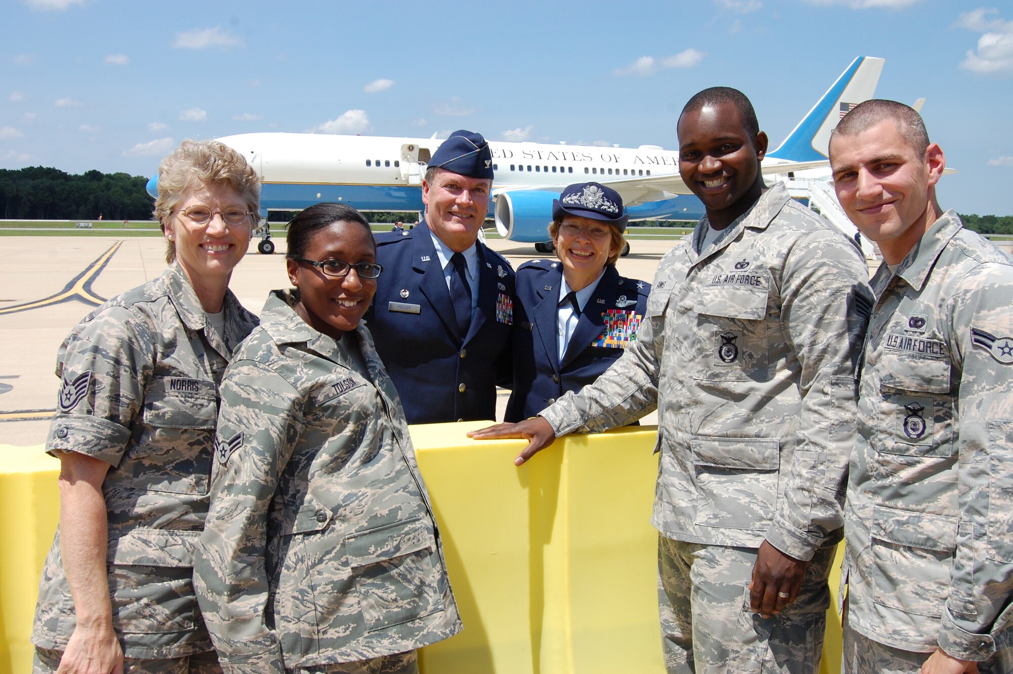 Staff Sgt. Gerilynn Norris, 166th Airlift Wing, Airman 1st Class Katesha Tolson, 166th Communications Flight, 166th Airlift Wing Commander Col. Mike Feeley, Delaware National Guard Assistant Adjutant General for Air Brig. Gen. Carol Timmons, Staff Sgt. Rahim Banks, 166th Security Forces Squadron, and Airman 1st Class Alvin Hall, 166th SFS pose for a photo with Air Force One in the background on July 17, 2014. U.S. President Barack Obama came to the home of the 166th Airlift Wing, Delaware Air National Guard en route to the Port of Wilmington, Delaware to announce a new initiative to increase private sector investment in our nation’s infrastructure. (U.S. Air National Guard photo by Tech. Sgt. Benjamin Matwey)