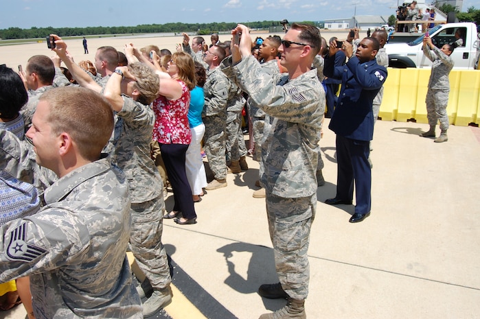 U.S. Air Force Airmen of the Delaware Air National Guard and civilian guests observe and take photos as Air Force One lands at the New Castle ANG Base on July 17, 2014. U.S. President Barack Obama came to the home of the 166th Airlift Wing, Delaware ANG en route to the Port of Wilmington, Delaware to announce a new initiative to increase private sector investment in our nation’s infrastructure. (U.S. Air National Guard photo by Tech. Sgt. Benjamin Matwey)