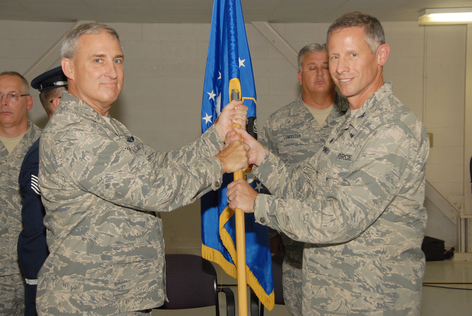 Chief of Staff of the Ohio Air National Guard, Brig. Gen. Stephen Markovich, hands the 178th Wing guidon to Col. Gregory Schnulo, commander 178th Wing, at Springfield Air National Guard Base, August 3, 2014.  This symbolized the transition of the 178th Fighter Wing becoming the 178th Wing. (Ohio Air National Guard photo by Master Sgt. Seth Skidmore/Released) 