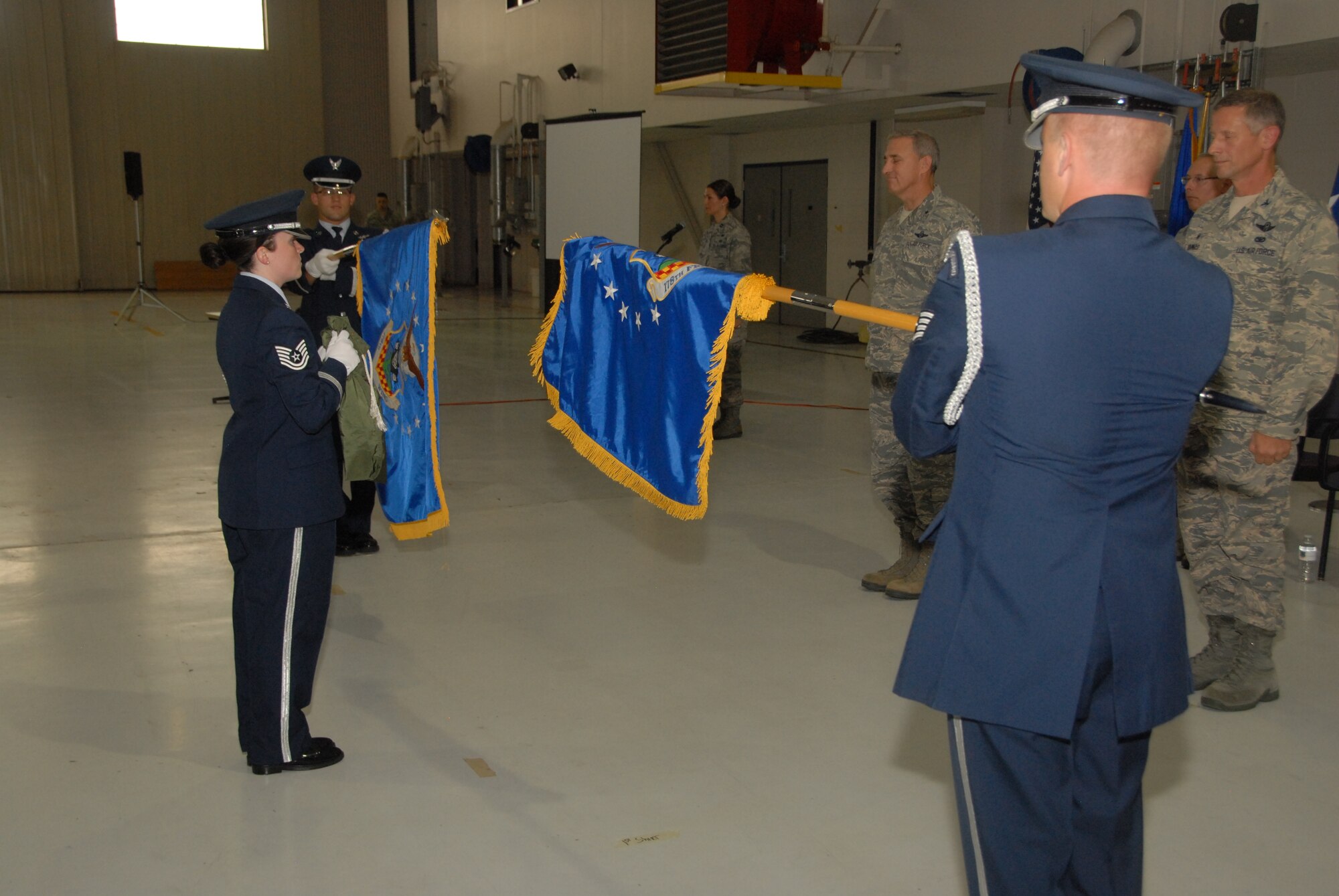 The 178th Honor Guard furls the 178th Fighter Wing Flag and unfurls the 178th Wing flag symbolizing the wings mission transition during a redesignation ceremony at the Springfield Air National Guard Base, Aug 3. While the name change was official July 1, the ceremony reflected a four-year conversion from the 178th FW that supported a flying mission to the 178th Wing, which now has intelligence, surveillance, reconnaissance and support missions. (Ohio Air National Guard photo by Master Sgt. Seth Skidmore/Released)