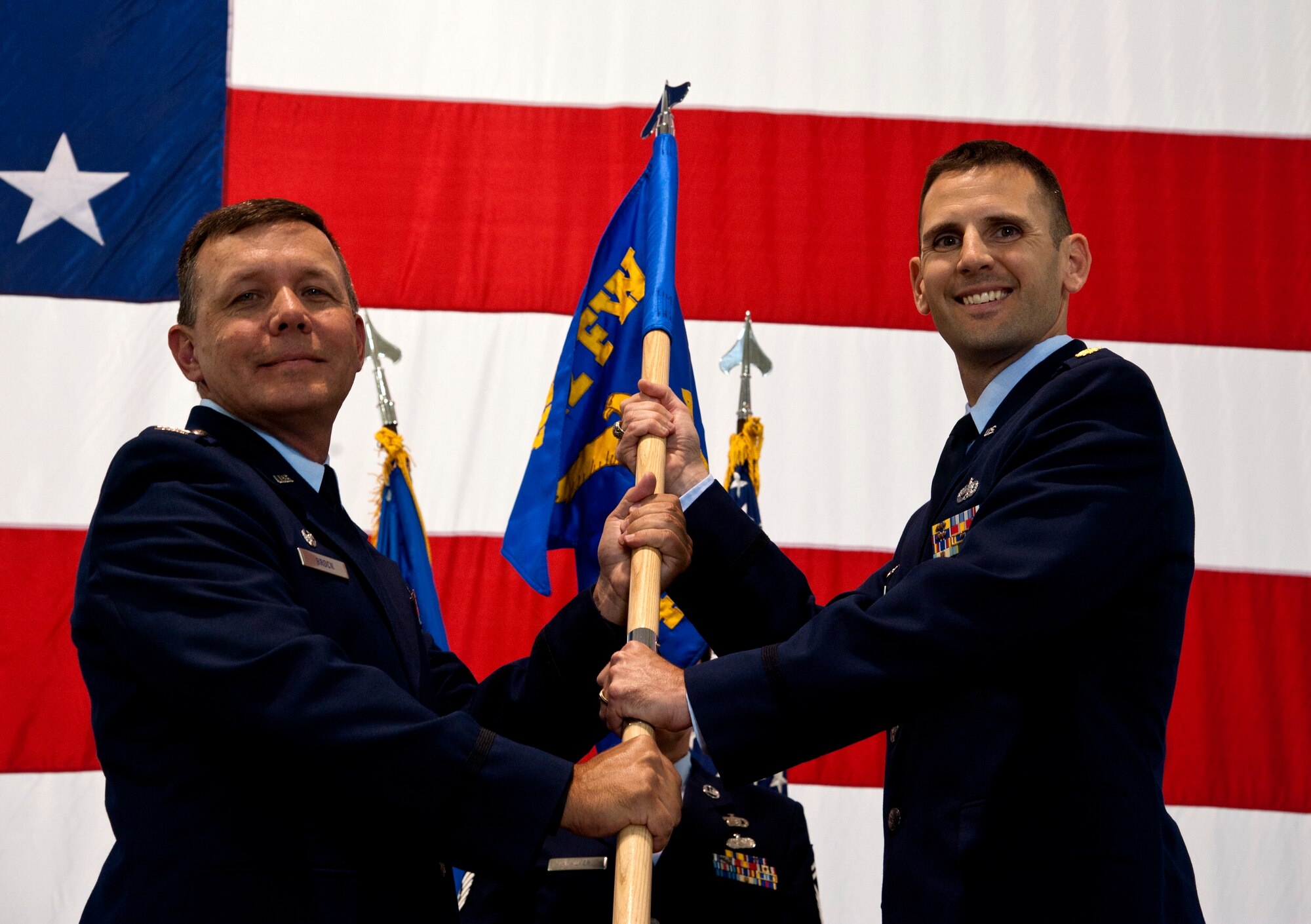 Maj. Daniel Posch, new 442d Aircraft Maintenance Squadron commnder, takes the guidon from Col. James Brock, 442d Maintenance Squadron commander, assuming command of the 442d AMXS Aug. 2, 2104 at Whiteman Air Force Base, Mo. Posch took over command in place of Maj. Christina Manning. (U.S. Air Force photo by Senior Airman Daniel Phelps/Released)