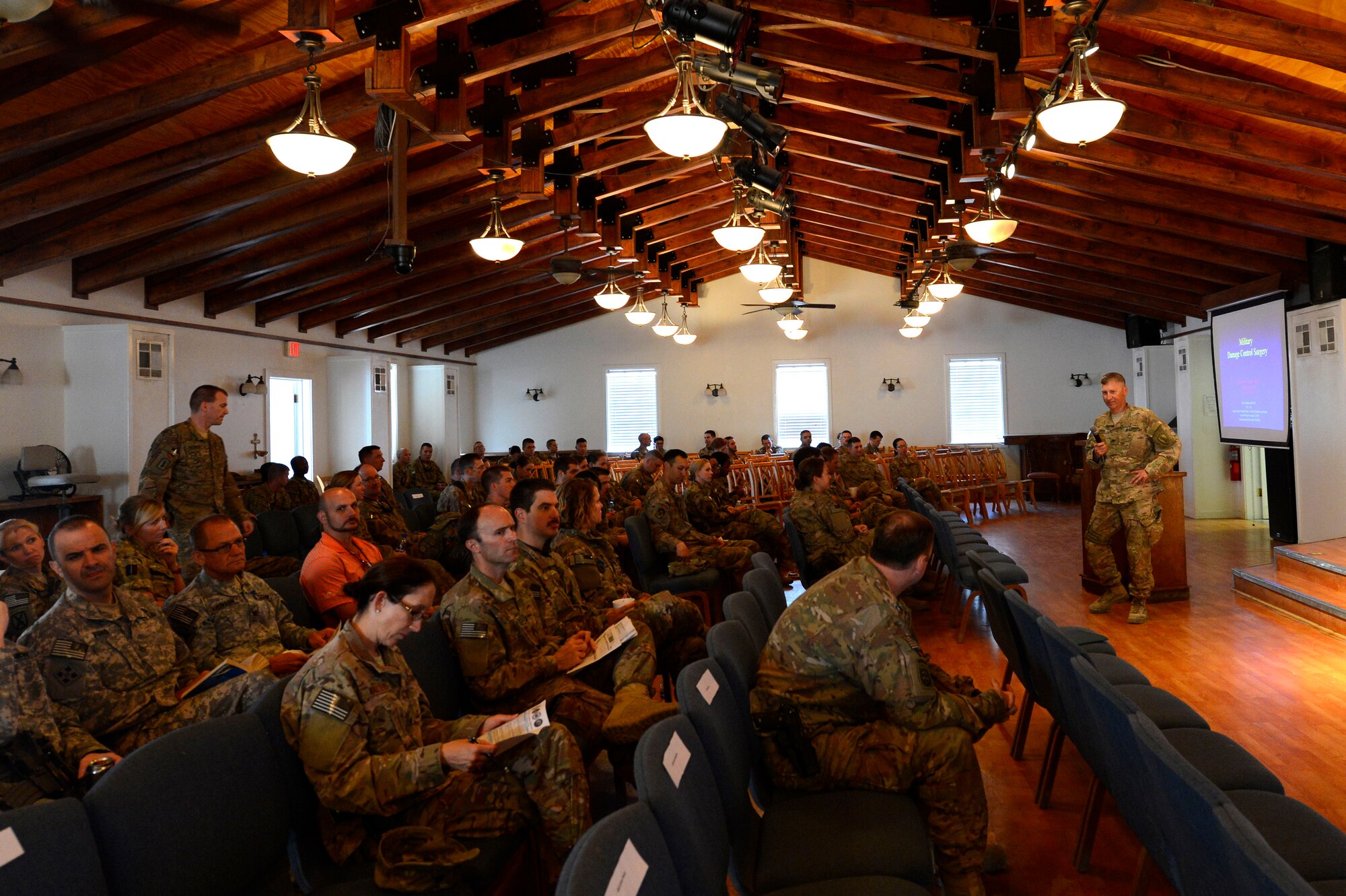 U.S. Army Col. Kirby Gross, Joint Theater Trauma System director, speaks at the fifth annual JTTS conference held in the Enduring Faith Chapel at Bagram Air Field, Afghanistan, July 11, 2014. More than 110 people attended the conference including military medical personnel from the United Kingdom, Australia, Spain, Italy and Germany. (U.S. Air Force photo by Senior Airman Sandra Welch)