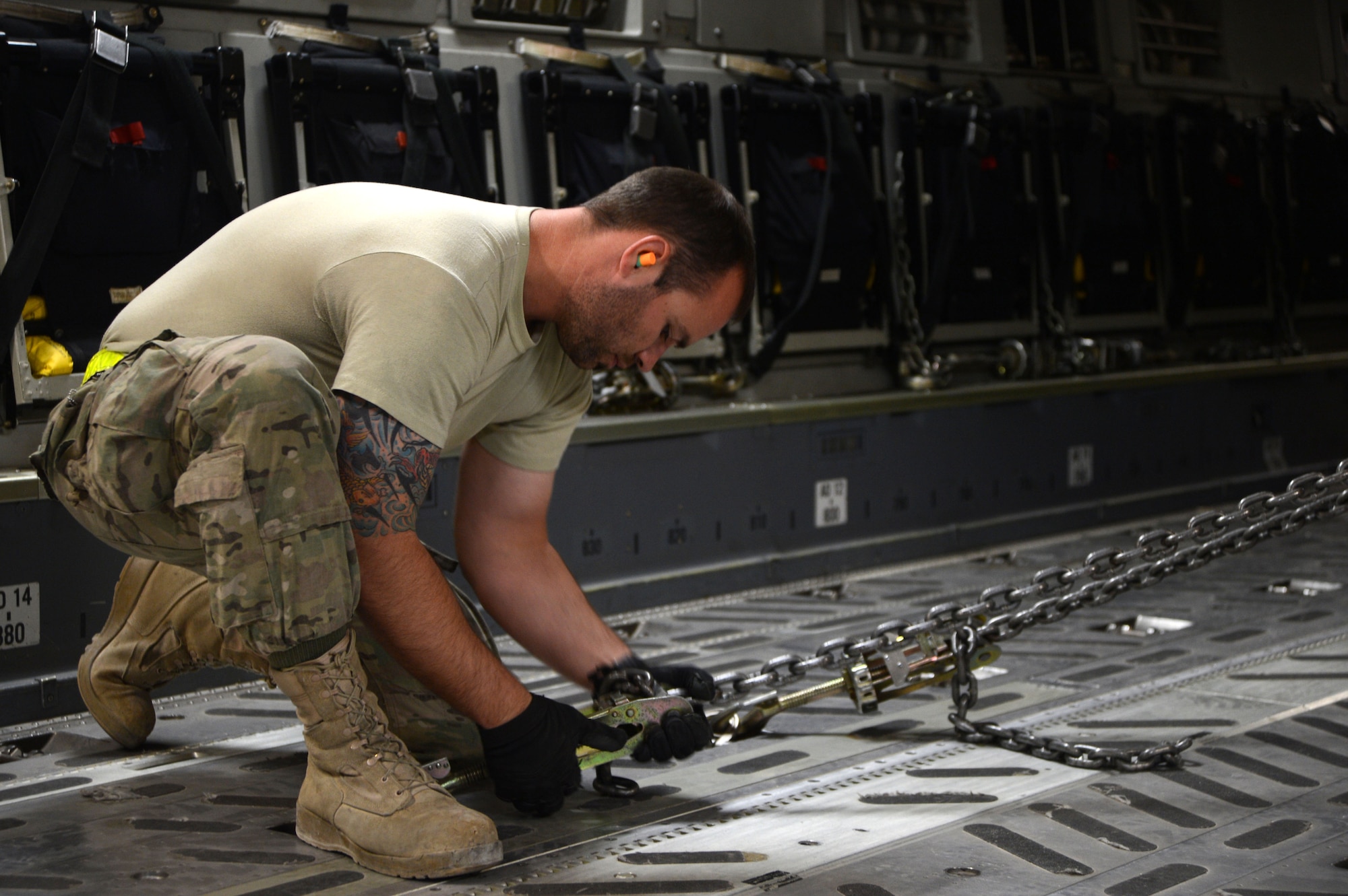 U.S. Air Force Senior Airman Jerry Hullette, a native of Lincolnton, N.C. and a ramp specialist assigned to the 455th Expeditionary Aerial Port Squadron, lock down chains supporting a Heavy Expanded Mobility Truck aboard a C-17 Globemaster III at Bagram Airfield, Afghanistan July 20, 2014. Airmen assigned to 455 EAPS worked with a C-17 crew to off-load six Afghan ambulatory vehicles and upload two HEMTT vehicles. Hullette is deployed from the 436th Aerial Port Squadron, Dover Air Force Base, Del. (U.S. Air Force photo by Master Sgt. Cohen A. Young/Released))