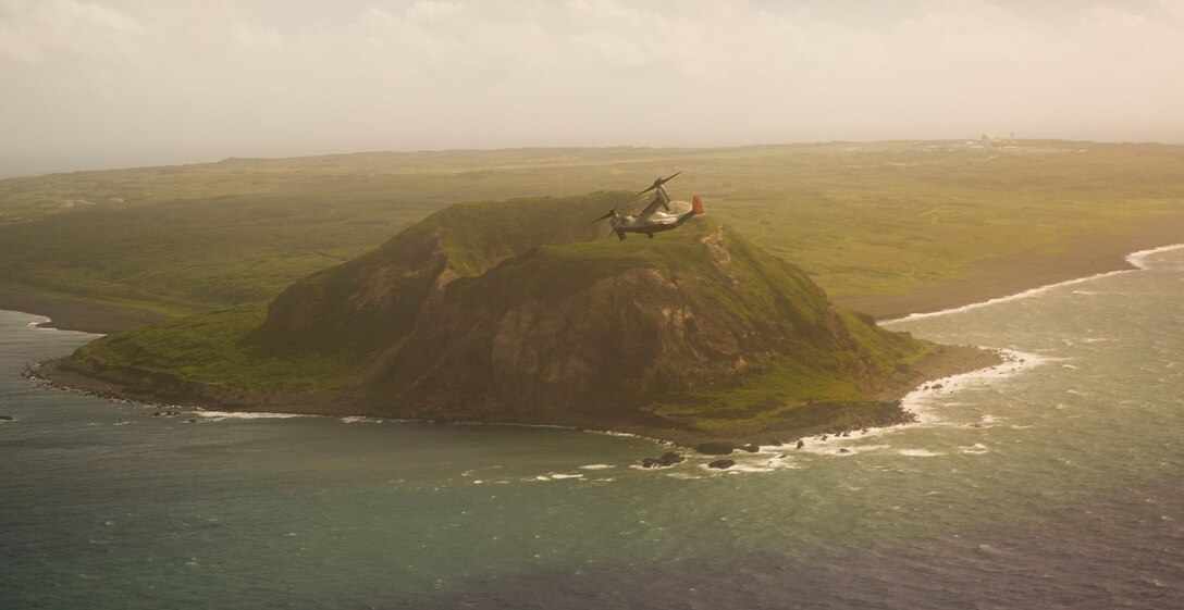 An MV-22B Osprey tiltrotor aircraft flies past Mount Suribachi July 28 at Iwo To, Japan, en route to Chichi Jima. Due to Chichi Jima’s remote location, the residents rely heavily on nearby Iwo To for medical and humanitarian relief. Given the long-range, heavy-lift capabilities of the Osprey, which have been consistently demonstrated during humanitarian assistance and disaster relief operations and exercises around the Asia-Pacific, the aircraft provides a reliable and effective means for response to future medical, humanitarian and relief needs. The Osprey and crew are with Marine Medium Tiltrotor Squadron 265, Marine Aircraft Group 36, 1st Marine Aircraft Wing, III Marine Expeditionary Force.