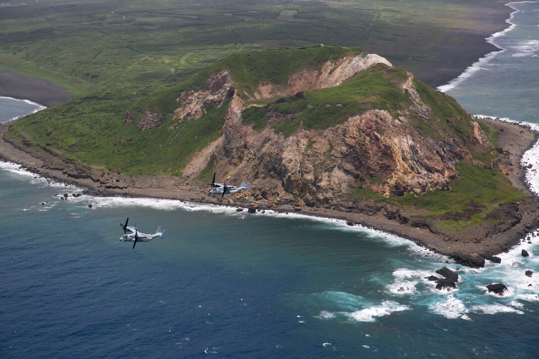 MV-22B Osprey tiltrotor aircraft fly past Mount Suribachi July 28 at Iwo To, Japan, en route to Chichi Jima. Due to Chichi Jima’s remote location, the residents rely heavily on nearby Iwo To for medical and humanitarian relief. Given the long-range, heavy-lift capabilities of the Osprey, which have been consistently demonstrated during humanitarian assistance and disaster relief operations and exercises around the Asia-Pacific, the aircraft provides a reliable and effective means for response to future medical, humanitarian and relief needs. The Ospreys and crew are with Marine Medium Tiltrotor Squadron 265, Marine Aircraft Group 36, 1st Marine Aircraft Wing, III Marine Expeditionary Force.