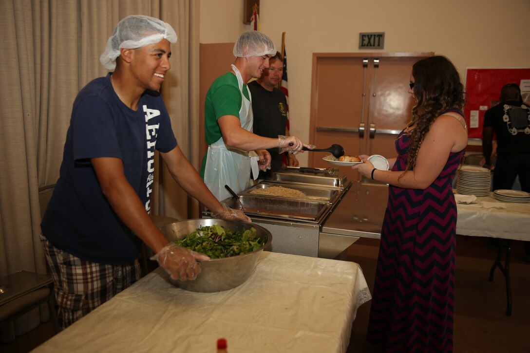 Food service specialists with 1st Tank Battalion, serve members of the Twentynine Palms community during a Food for Life event at the Little Church of The Desert, July 12, 2014.


