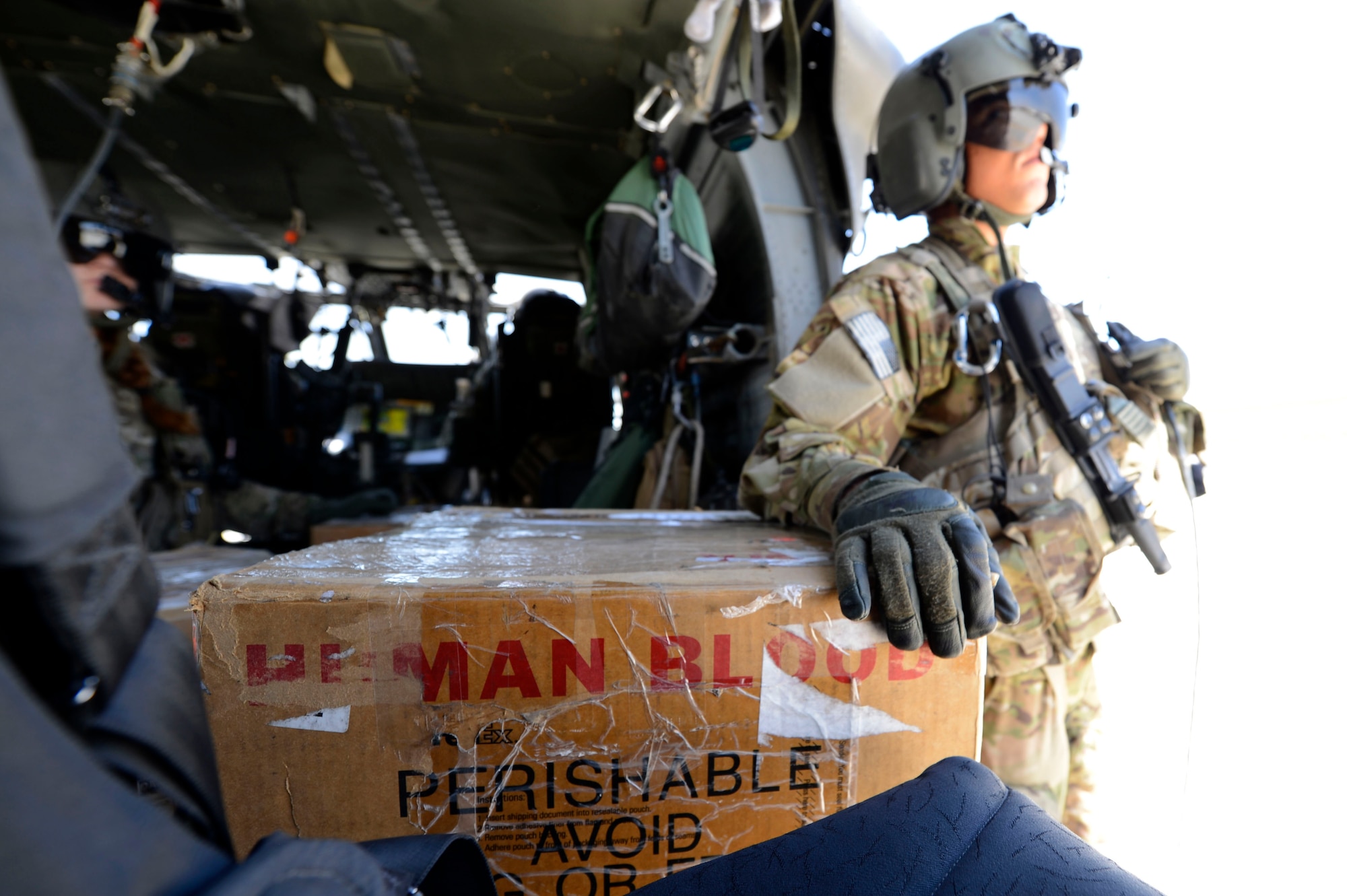 U.S. Army Spc. Robert Moher, 159th Combat Aviation Brigade crew chief, stands by to deliver blood in Afghanistan, July 2014. Moher, a Harlem, N.Y. native, is deployed from Fort Campbell, Ky. Joint Theater Trauma System members ensure fresh blood is always on hand. (U.S. Air Force photo by Senior Airman Sandra Welch)