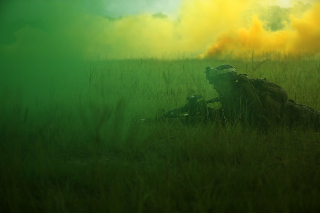 A Marine with India Company, Battalion Landing Team 3rd Battalion, 6th Marine Regiment, 24th Marine Expeditionary Unit, lies down behind a smoke screen during live-fire maneuver training at Camp Lejeune, N.C., July 22, 2014. The 24th MEU is currently conducting a Realistic Urban Training exercise, their first major pre-deployment training event in preparation for their deployment at the end of the year. (U.S. Marine Corps photo by Lance Cpl. Joey Mendez)