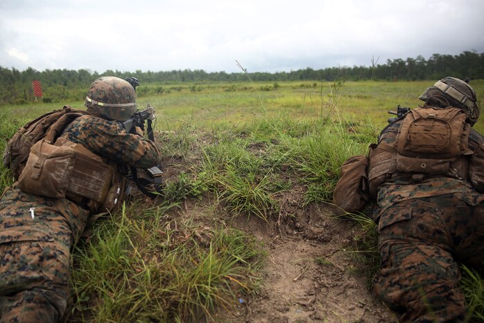 Marines with India Company, Battalion Landing Team 3rd Battalion, 6th Marine Regiment, 24th Marine Expeditionary Unit, fire service rifles at simulated enemies during live-fire maneuver training at Camp Lejeune, N.C., July 22, 2014. The 24th MEU is currently conducting a Realistic Urban Training exercise, their first major pre-deployment training event in preparation for their deployment at the end of the year. (U.S. Marine Corps photo by Lance Cpl. Joey Mendez)