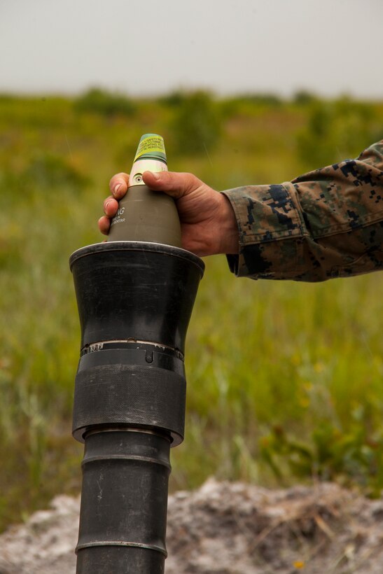 A mortarman with the 24th Marine Expeditionary Unit’s Ground Combat Element, Battalion Landing Team 3rd Battalion, 6th Marine Regiment, drops an 81mm high-explosive mortar in the tube of an M-252 81mm Mortar System during a live-fire exercise at Camp Lejeune, N.C., July 23, 2014. The 24th MEU is currently conducting a Realistic Urban Training exercise, their first major pre-deployment training event in preparation for their deployment at the end of the year.