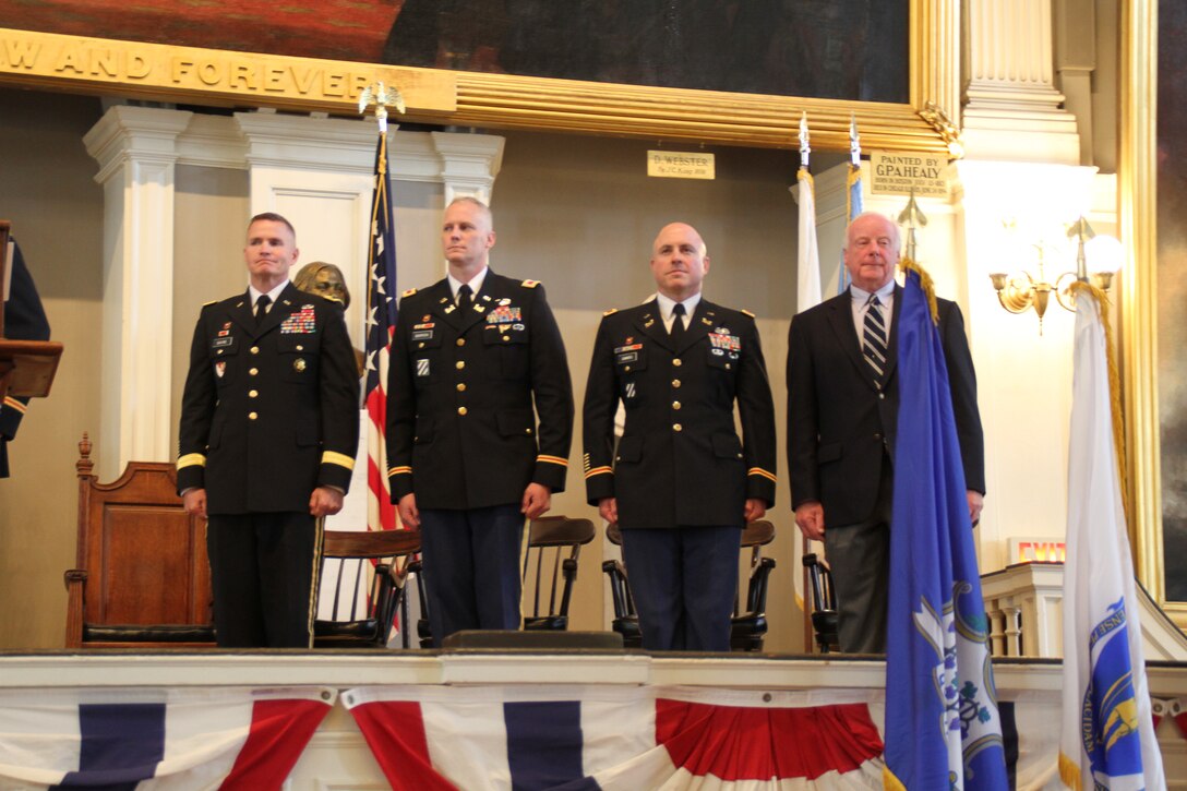 Brig. Gen. Kent Savre, commander, North Atlantic Division; Col. Christopher Barron, district engineer and commander, New England District; Col. Charles Samaris, outgoing commander; and Bill Scully, deputy district engineer for Project Management; all of the U.S. Army Corps of Engineers,  stand at attention as the colors are retired at the New England District Change of Command Ceremony at Faneuil Hall, Boston, Mass. 