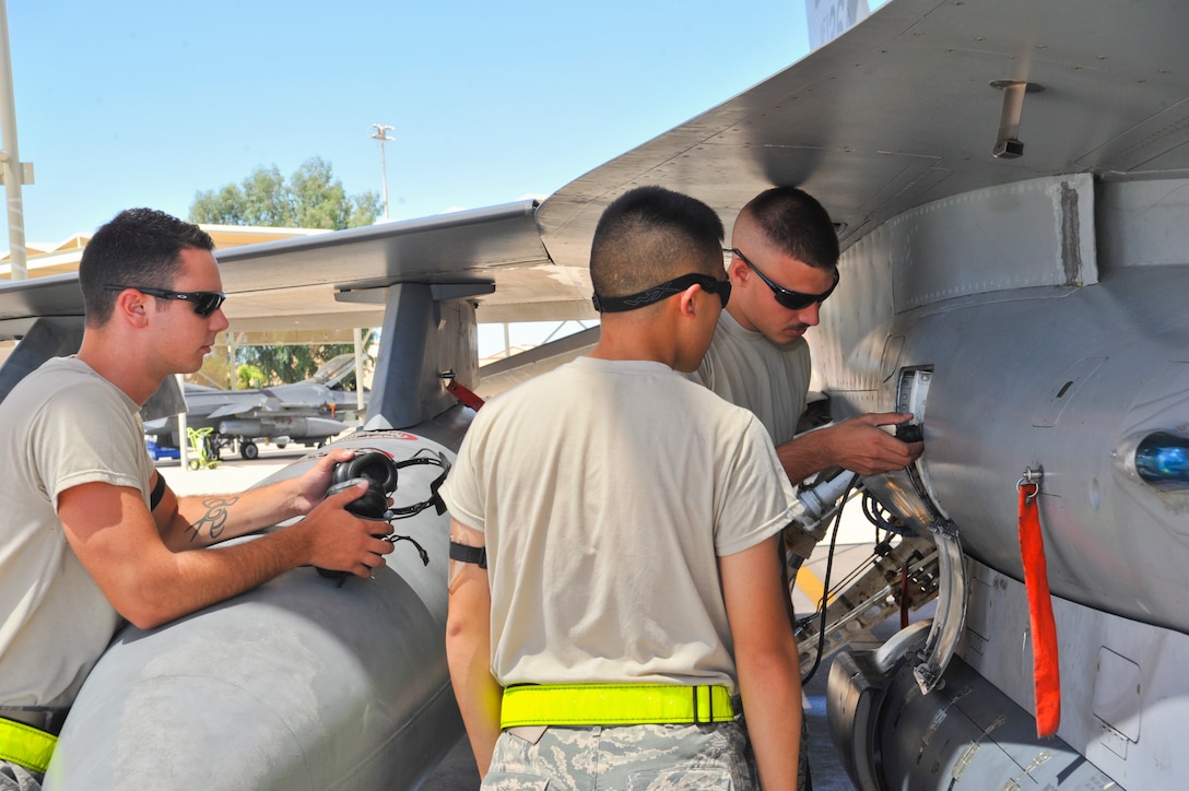 Detachment 12, 372nd Training Squadron mission-ready Airmen, or MRA, perform a preflight check July 21, 2014, on an F-16 Fighting Falcon at Luke Air Force Base, Ariz. The MRA program teaches Airmen F-16 launching, recovering, and pre- and post-flight inspections preparing them to maintain aircraft at their duty stations. (U.S. Air Force photo/Airman 1st Class Cory Gossett)