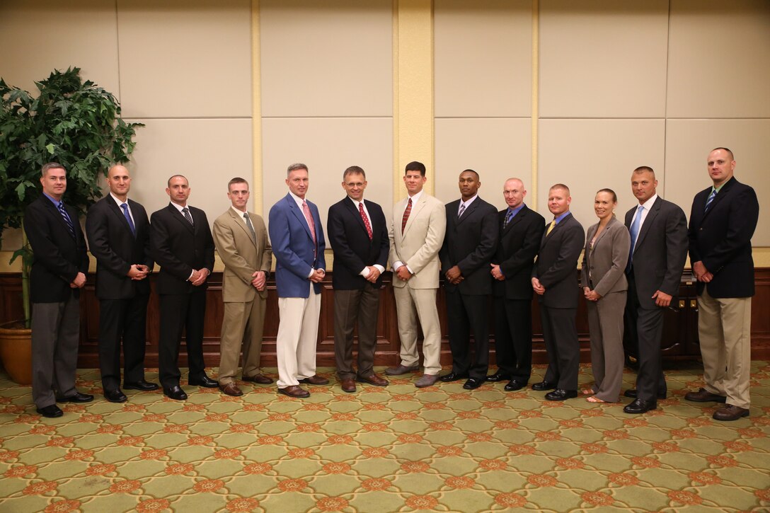 6th Marine Corps District officers attending the 8412 Symposium pose for a photo during the professional dinner at Keesler Air Force Base, Miss., July 30. 