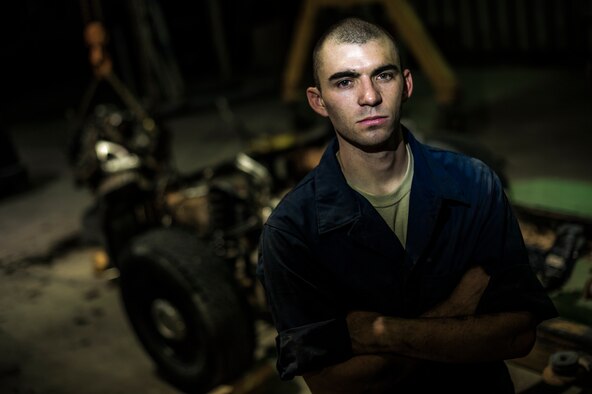 Senior Airman Christopher Moore, 386th Expeditionary Logistics Readiness Squadron vehicle mechanic, removes the engine of a truck July 18, 2014 at an undisclosed location in Southwest Asia. Moore has been a mechanic for the Air Force for three years and deployed from the 86th Vehicle Readiness Squadron, Ramstein Air Base, Germany in support of Operation Enduring Freedom. (U.S. Air Force photo by Staff Sgt. Jeremy Bowcock)