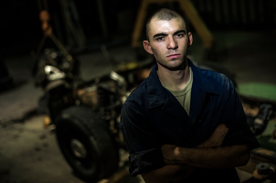 Senior Airman Christopher Moore, 386th Expeditionary Logistics Readiness Squadron vehicle mechanic, removes the engine of a truck July 18, 2014 at an undisclosed location in Southwest Asia. Moore has been a mechanic for the Air Force for three years and deployed from the 86th Vehicle Readiness Squadron, Ramstein Air Base, Germany in support of Operation Enduring Freedom. (U.S. Air Force photo by Staff Sgt. Jeremy Bowcock)