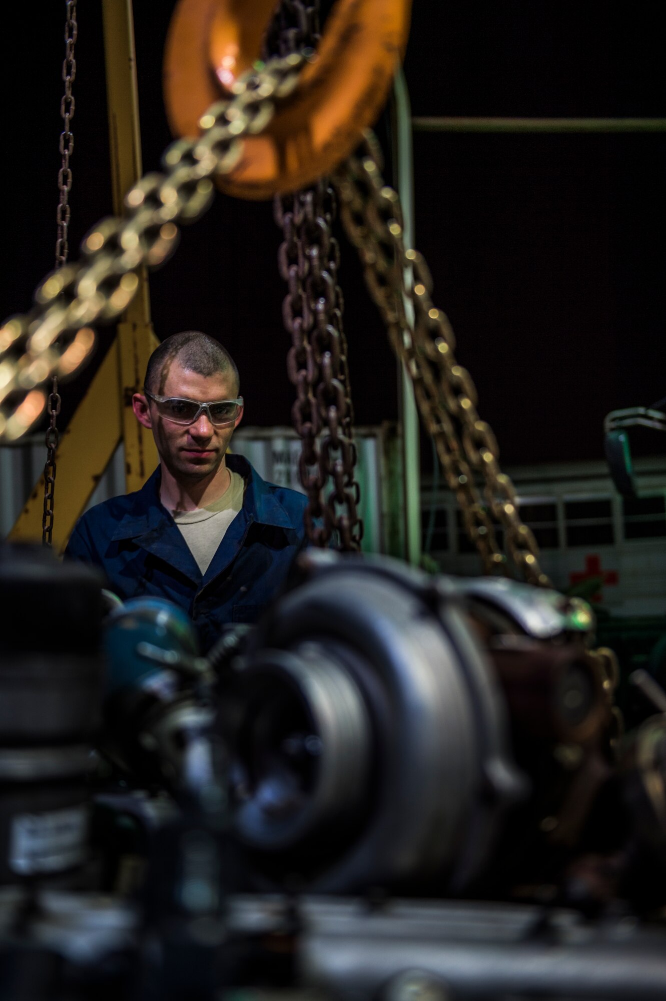 Senior Airman Christopher Moore, 386th Expeditionary Logistics Readiness Squadron vehicle mechanic, removes the engine of a truck July 18, 2014 at an undisclosed location in Southwest Asia. Moore has been a mechanic for the Air Force for three years and deployed from the 86th Vehicle Readiness Squadron, Ramstein Air Base, Germany in support of Operation Enduring Freedom. (U.S. Air Force photo by Staff Sgt. Jeremy Bowcock