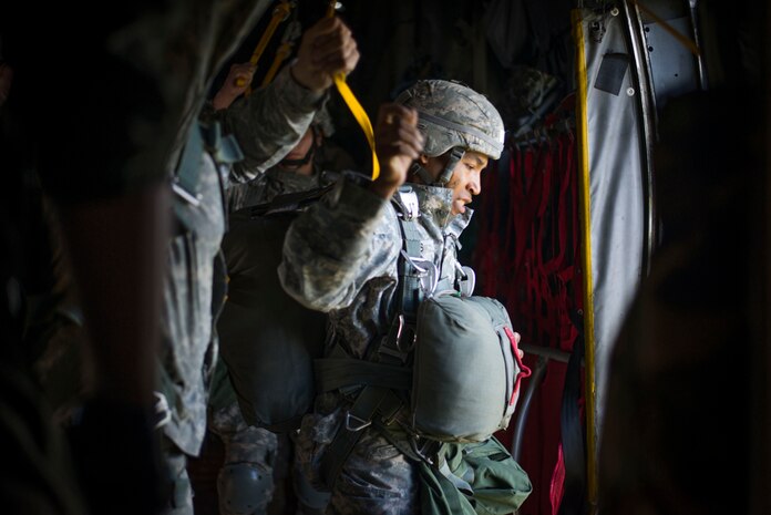 YOKOTA AIR BASE, Japan (Aug. 1, 2014) - An Army Paratrooper from the 725th Brigade Support Battalion runs to the troop door of a C-130 Hercules from the 36th Airlift Squadron prior to parachuting over the drop zone during a training sortie at Joint Base Elmendorf-Richardson, Alaska. For several paratroopers, this was the first jump to initiate their training. (U.S. Air Force photo by Staff Sgt. Chad C. Strohmeyer) 