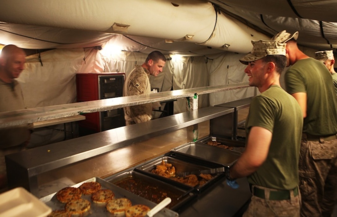 Food service specialists with 1st Battalion, 7th Marine Regiment, prepare to serve troops at the Harvest Falcon dining facility aboard Camp Dwyer, Helmand province, Afghanistan, July 21, 2014. The food service Marines at the Harvest Falcon are in charge of making sure meals are served at the correct temperature, the facility is cleaned daily and food is cooked properly for every meal. (U.S. Marine Corps photo by Cpl. Cody Haas/ Released)
