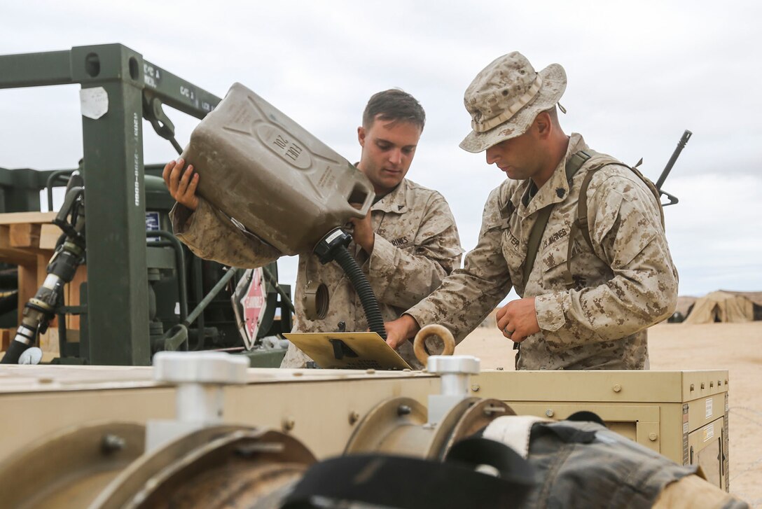 Marines with Brigade Headquarters Group, 1st Marine Expeditionary Brigade, refuel a generator at Camp Francis during Large Scale Exercise 2014 aboard the Marine Corps Air Ground Combat Center Twentyninepalms, Calif., Aug. 2, 2014. LSE-14, being conducted from Aug. 8-14, is a bilateral training exercise between the U.S. and Canada which includes live, simulated, and constructive operations to enhance both countries’ ability to activate and deploy a Marine Air Ground Task Force with speed and effectiveness in support of the full range of military operations as required by combatant commanders. (U.S. Marine Corps photo by Lance Cpl. Caitlin Bevel)