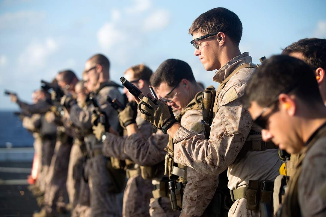 Marines with the Force Reconnaissance Detachment, 11th Marine Expeditionary Unit, reload after firing their Marine Corps Close Quarters Battle Pistols during live-fire sustainment training aboard the USS San Diego, Pacific Ocean, Aug. 1, 2014. The Marines of the Force Reconnaissance Detachment keep their skills current through practice and familiarization drills while deployed in support of WESTPAC 14-2.  (U.S. Marine Corps photo by Gunnery Sgt. Rome M. Lazarus/Released)