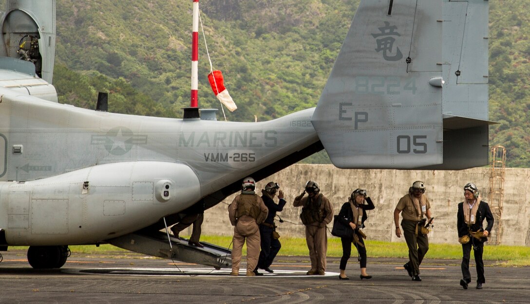 Itsunori Onodera, far right, Lt. Gen. John Wissler, second from right, and members of the Ministry of Defense for Japan exit an MV-22B Osprey tiltrotor aircraft July 28 on Chichi Jima, Japan. Onodera and Wissler arrived via Osprey to demonstrate the long-range and quick response capabilities of the aircraft in the event of humanitarian assistance and disaster relief efforts. Due to Chichi Jima’s remote location, the residents rely heavily on nearby Iwo To for medical and humanitarian relief. Given the capabilities of the Osprey, which have been consistently demonstrated during humanitarian assistance and disaster relief operations and exercises around the Asia-Pacific, it provides a reliable and effective means for responding to future medical, humanitarian and relief needs. Wissler is the commanding general of III Marine Expeditionary Force. Onodera is the minister of defense for Japan. The Osprey and crew are with Marine Medium Tiltrotor Squadron 265, Marine Aircraft Group 36, 1st Marine Aircraft Wing, III MEF.