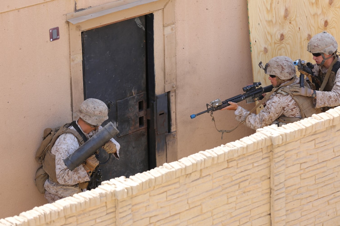 A fire team attending the 1st Marine Division Schools, Urban Leaders Course, prepare for a mechanical breach during a training event aboard Camp Pendleton, California, July 28, 2014. Marines from 1st Light Armored Reconnaissance Battalion, 3rd Battalion 1st Marine Regiment and 1st Combat Engineers Battalion all attended the course.
