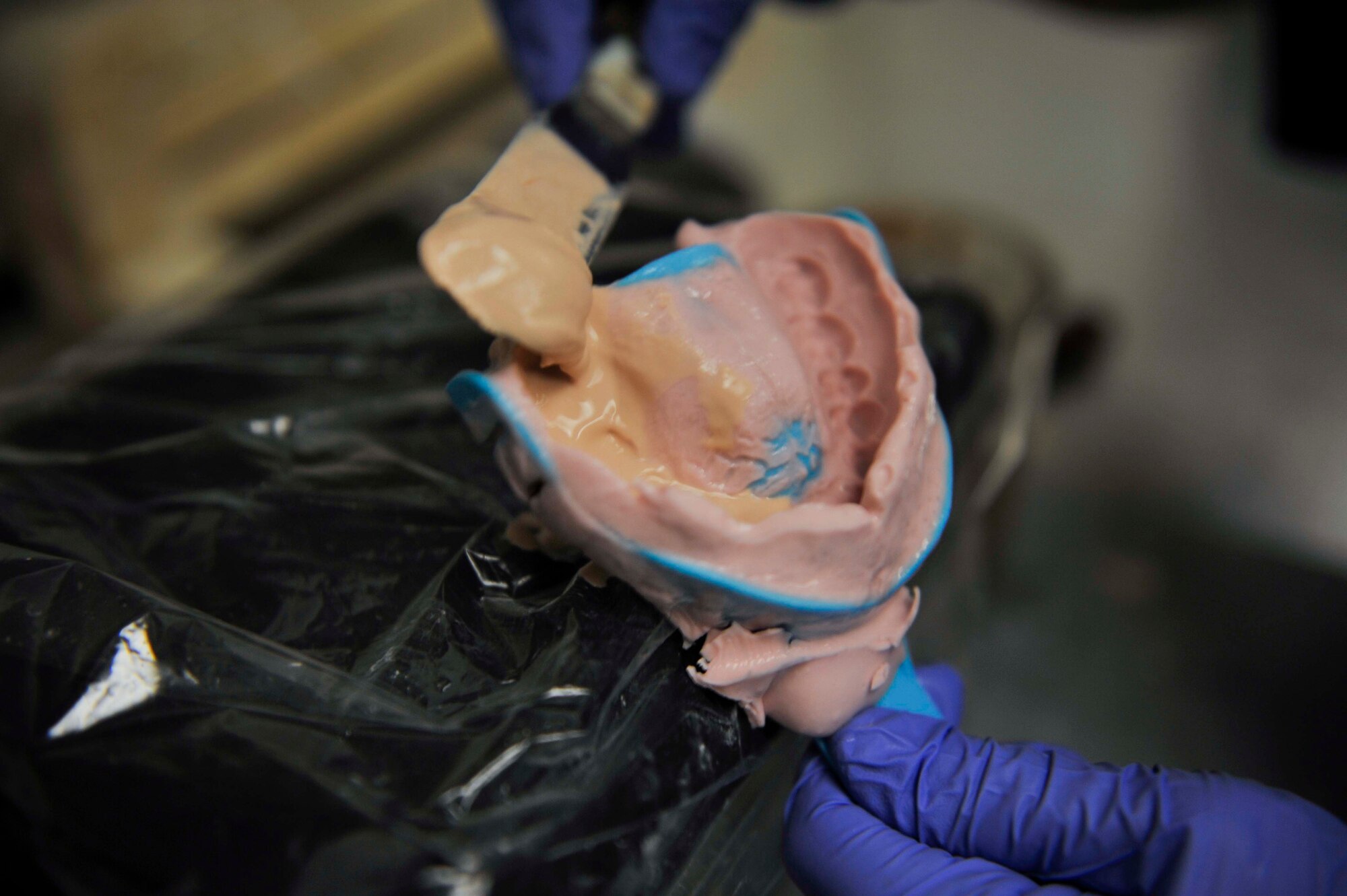 Staff Sgt. Janine Sung, 51st Dental Squadron laboratory technician, pours a mixture of peach stone and water into a mouth impression on Osan Air Base, Republic of Korea, July 31, 2014. Different types of stone are used depending on what the appliance is for. (U.S. Air Force photo/Senior Airman David Owsianka)