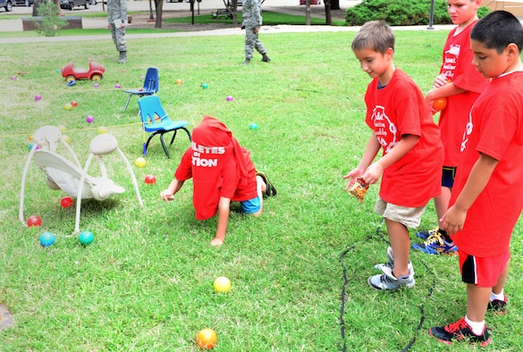 Students cheer their teammate on at the Student Connection Round-Up confidence course Aug. 1, 2014 at Cannon Air Force Base, N.M. The round-up was designed to help military children at Cannon build new friendships before the start of the school year. (U.S. Air Force Photo/Airman 1st Class Shelby Kay-Fantozzi)