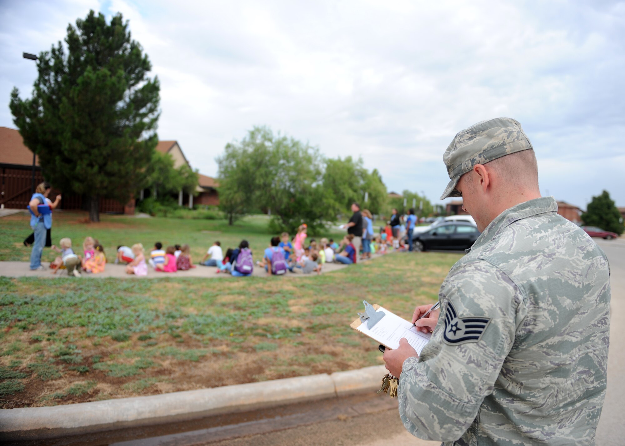U.S. Air Force Staff Sgt. Shayne Anglin, 7th Civil Engineer Squadron fire prevention inspector, performs a routine fire drill at the Child Development Center (CDC) July 30, 2014, at Dyess Air Force Base, Texas. To ensure everyone can exit the building within a reasonable time, fire drills are performed at the CDC and Youth Center monthly and can be performed, if requested, by an agency. (U.S. Air Force photo by Airman 1st Class Autumn Velez/Released)