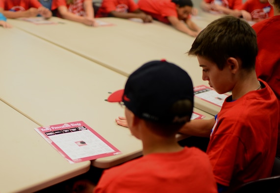 Students lay down their first chips during bully prevention bingo at the Student Connection Round-Up Aug. 1, 2014 at Cannon Air Force Base, N.M. The round-up was designed to help military children at Cannon build new friendships before the start of the school year. (U.S. Air Force Photo/Airman 1st Class Shelby Kay-Fantozzi)