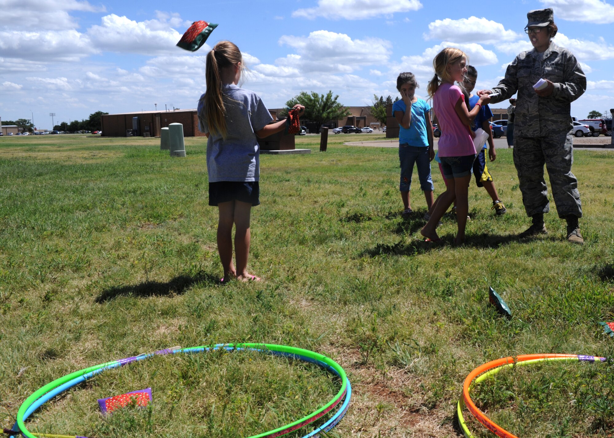 Children play the beanbag toss July 30, 2014 at the carnival celebrating the end of the summer reading program at Cannon Air Force Base, N.M. The library hosts a reading program which encourages kids, teens and their parents to spend the summer reading. (U.S. Air Force photo/Senior Airman Ericka Engblom)