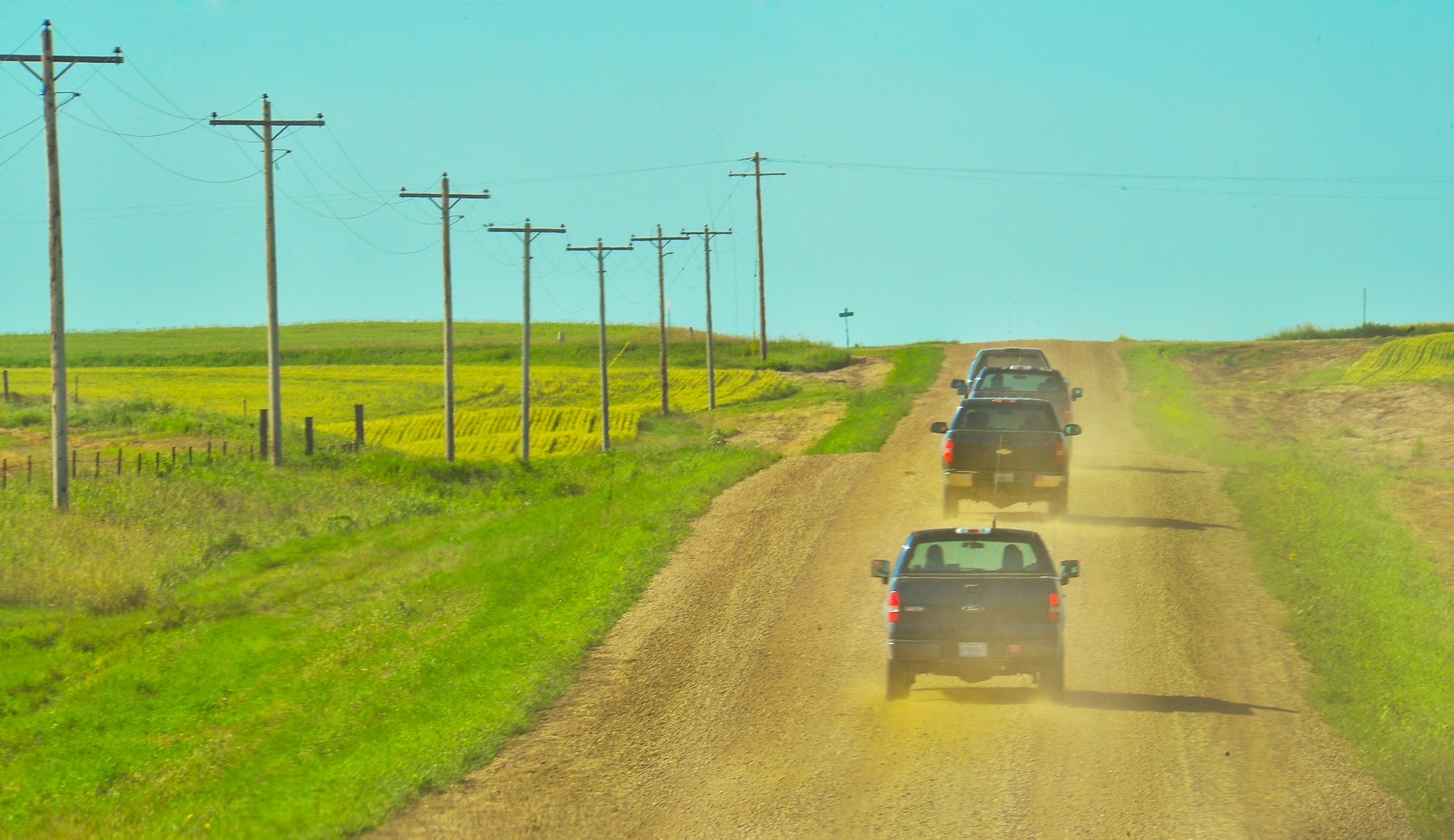 Airmen from the 91st Missile Maintenance Squadron hardened intersite cable system section, drive to a missile alert facility in North Dakota, July 21, 2014. Their primary mission is to maintain the HICS network, comprised of 1,535 linear miles of cable and 47 cable air dryers spanning across 8,500 square miles of land. (U.S. Air Force photo/Senior Airman Brittany Y. Bateman)