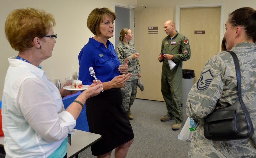 Kris Heick, Airman & Family Readiness Center community readiness consultant, talks with visitors during the Grand Opening event July 31, 2014, at Creech Air Force Base, Nev. The new location includes a larger classroom, private offices and free Wi-Fi to allow the A&FRC to provide enhanced services. (U.S. Air Force photo by Tech. Sgt. Shad Eidson/Released)