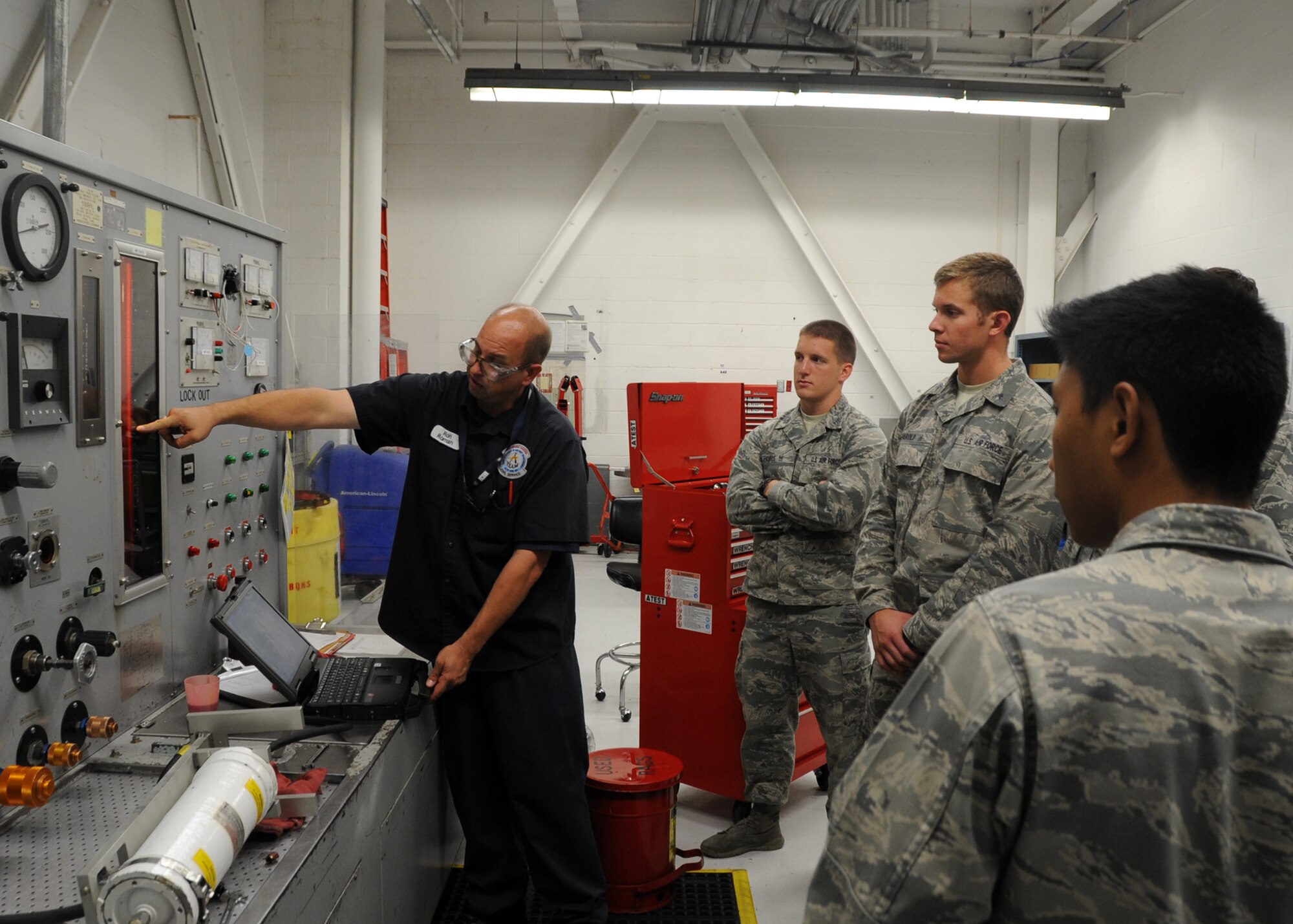 ALTUS AIR FORCE BASE, Okla. – Ron Roman, 97th Maintenance Directorate hydraulics specialist, shows U.S. Air Force Academy cadets how to operate a hydraulics component tester, July 30, 2014. The cadets visited the 97th Air Mobility Wing for more than two weeks to observe different career fields within the U.S. Air Force. (U.S. Air Force photo by Senior Airman Franklin R. Ramos/Released)