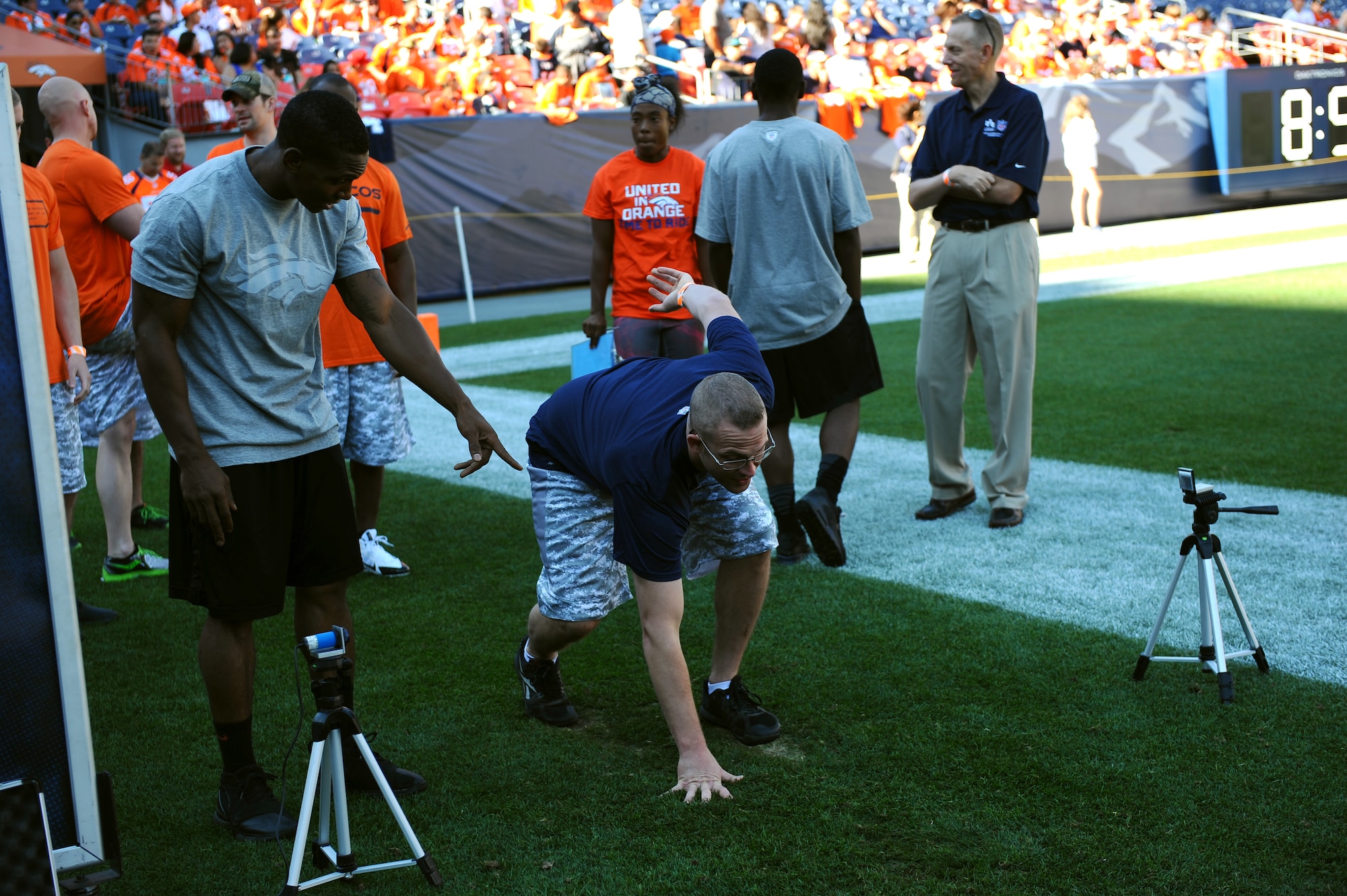 Tech. Sgt. Scott Lauer, 10th Medical Group, attempts the 40-yard dash during an NFL-style combine event for military members, hosted by USAA and the Denver Broncos, at Sports Authority Field Aug. 2. (U.S. Air Force photo/Tech. Sgt. Heather Stanton)