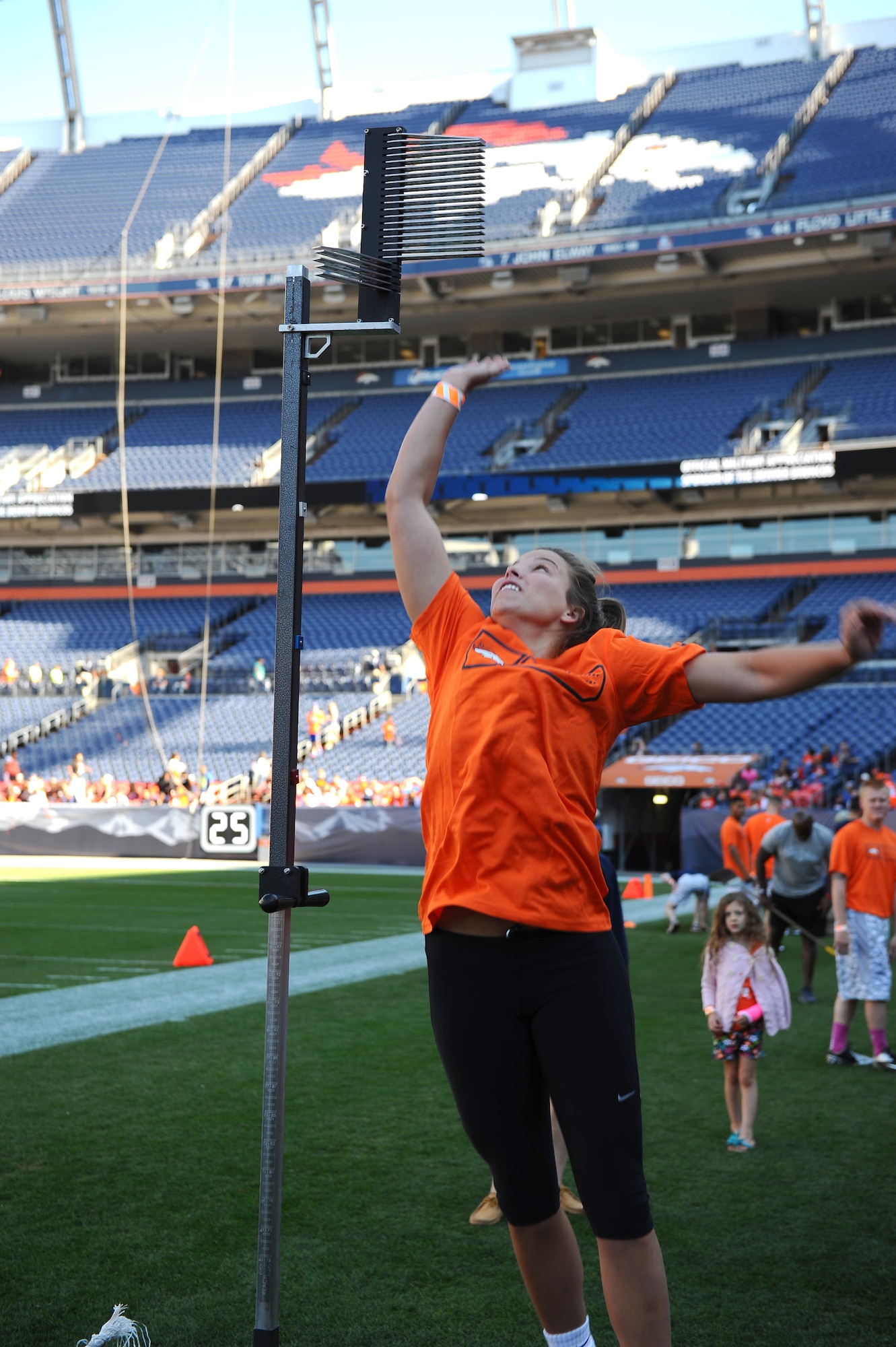 Cadet 1st Class Cayce Dossett, Cadet Squadron 34, attempts a vertical leap during an NFL-style combine event for military members, hosted by USAA and the Denver Broncos, at Sports Authority Field Aug. 2. Dossett was named top female for the combine. (U.S. Air Force photo/Tech. Sgt. Heather Stanton)