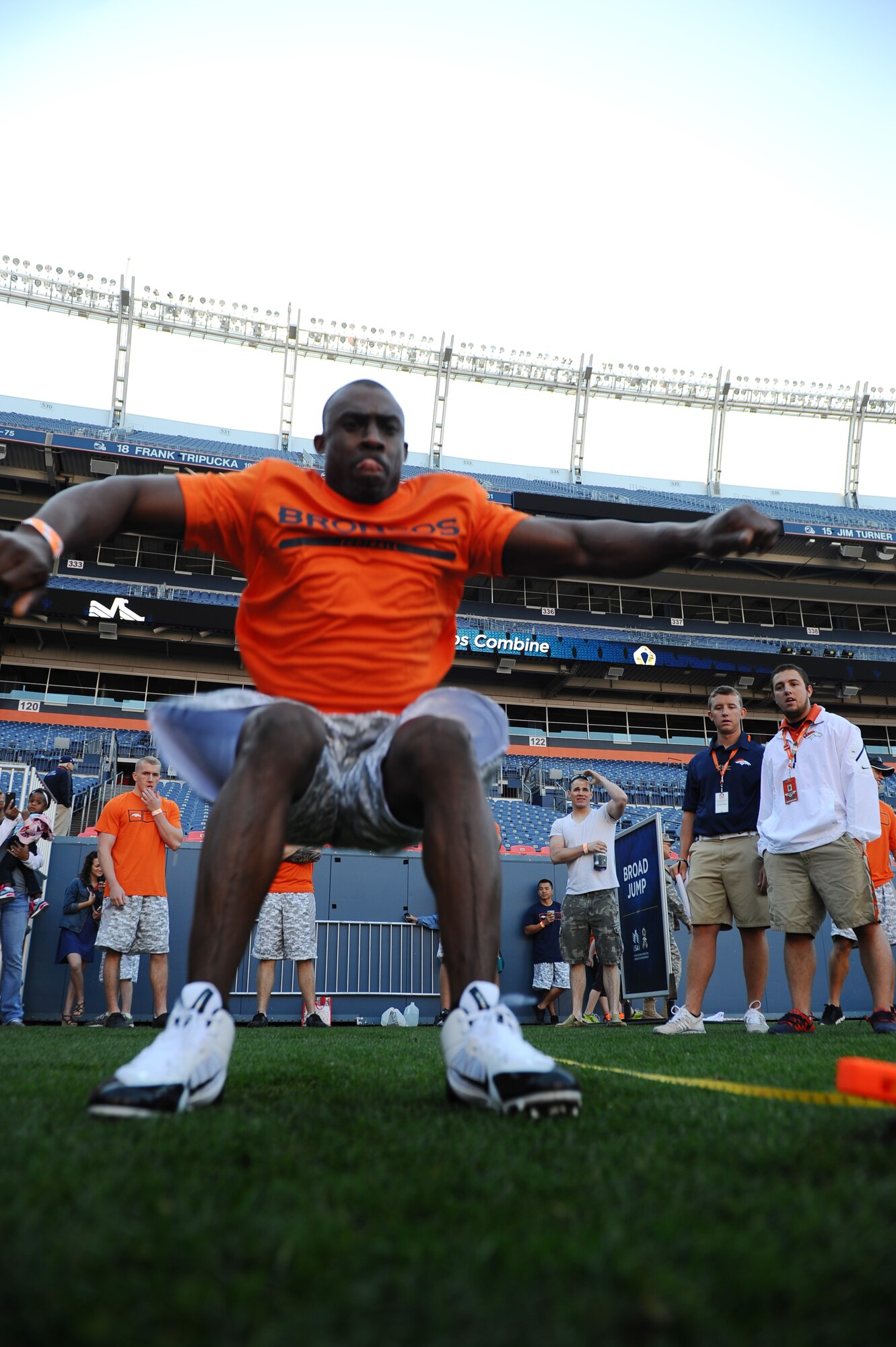 Tech. Sgt. Christopher Ryals, 10th Medical Group, attempts a broad jump during an NFL-style combine event for military members, hosted by USAA and the Denver Broncos, at Sports Authority Field Aug. 2. Ryals was named top male for the combine. (U.S. Air Force photo/Tech. Sgt. Heather Stanton)