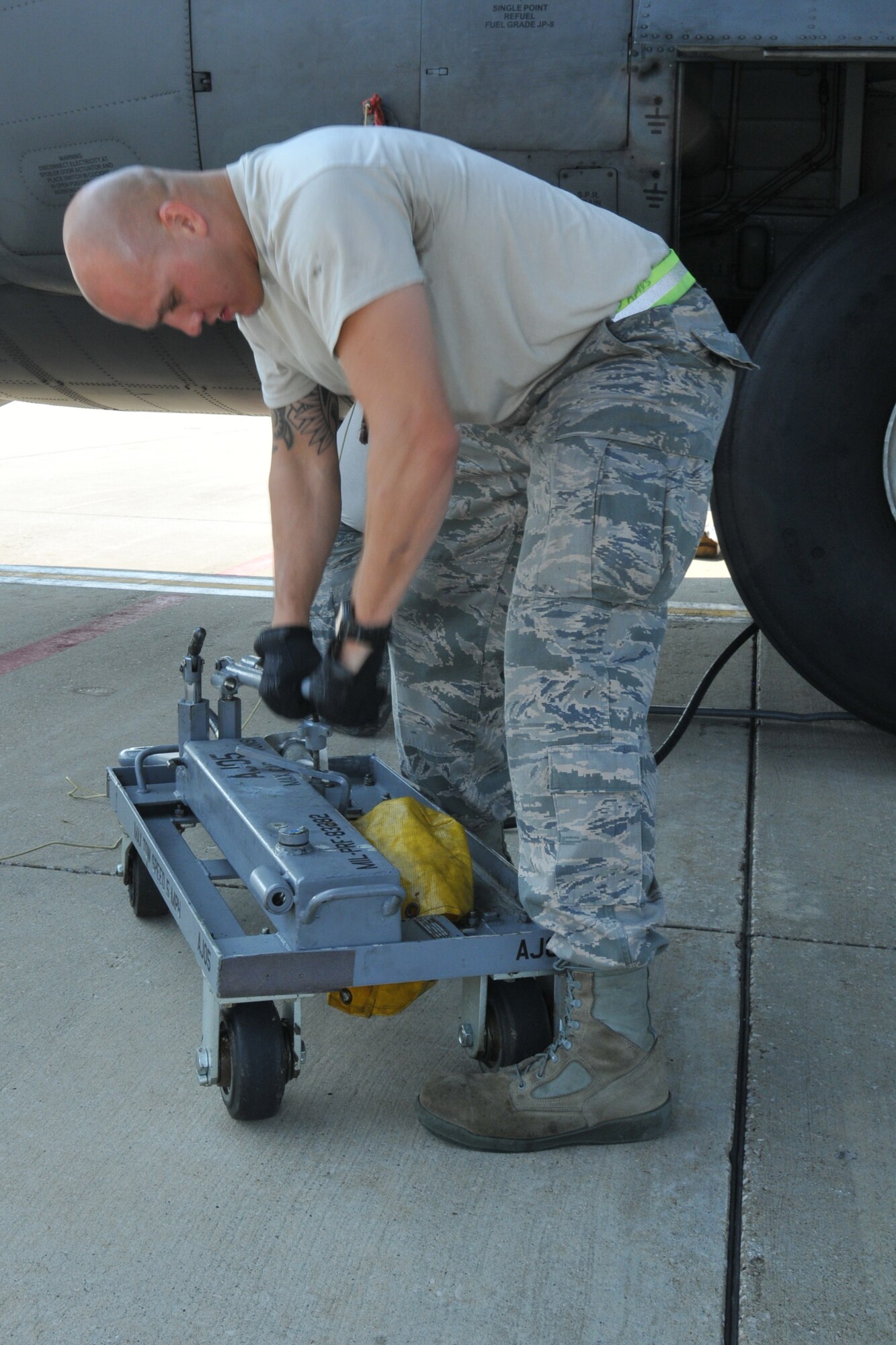 Staff Sgt. Ethan Slark, a 910th Airlift Wing maintainer, pressurizes a hydraulic jack during a routine C-130 tire change here, August 2, 2014. U.S. Air Force photo/Tech. Sgt. Jim Brock.
